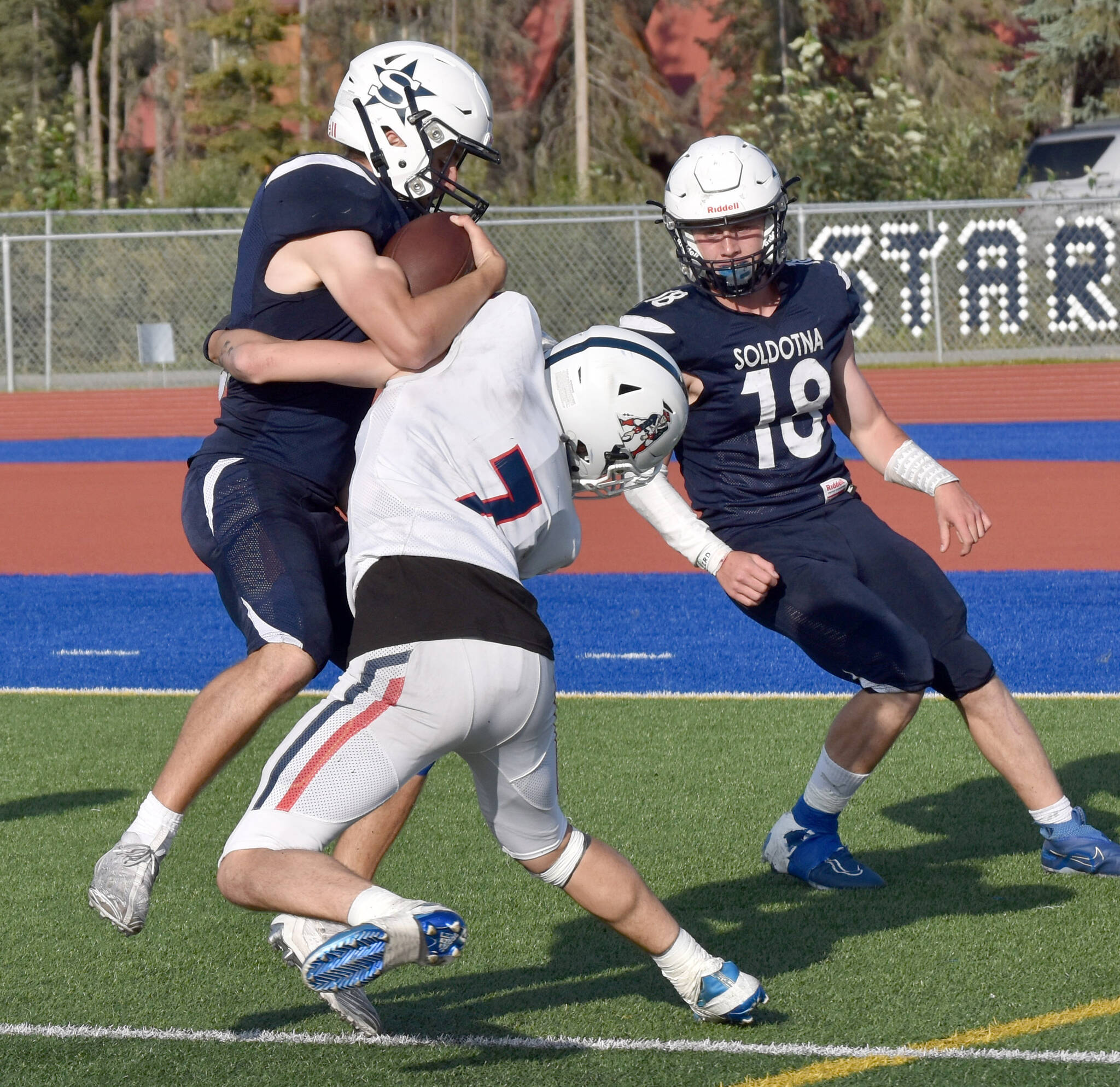 Soldotna’s Zac Buckbee crashes through Logen Bellmay for a touchdown Friday, Aug. 18, 2023, at Justin Maile Field at Soldotna High School in Soldotna, Alaska. (Photo by Jeff Helminiak/Peninsula Clarion)