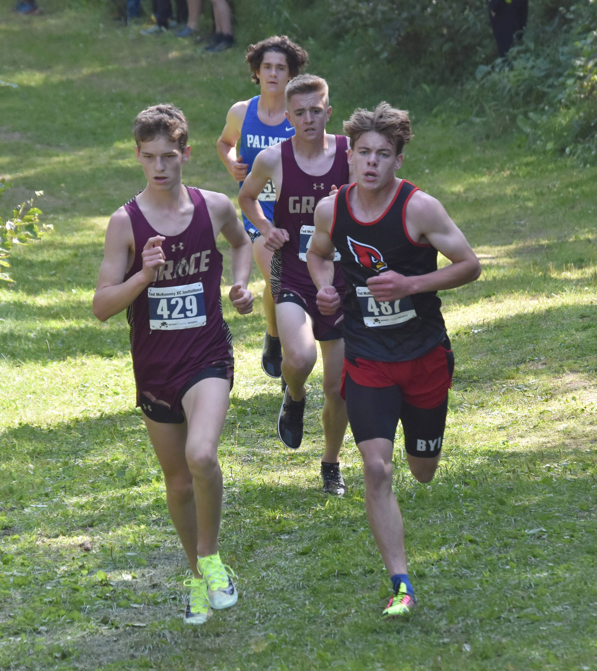 Grace Christian’s Robbie Annett and Kenai Central’s Greg Fallon, trailed by Grace’s Simon Nelson and Palmer’s Fischer Adams, lead the boys varsity race at the Ted McKenney Invitational on Saturday, Aug. 19, 2023, at Tsalteshi Trails just outside of Soldotna, Alaska. (Photo by Jeff Helminiak/Peninsula Clarion)