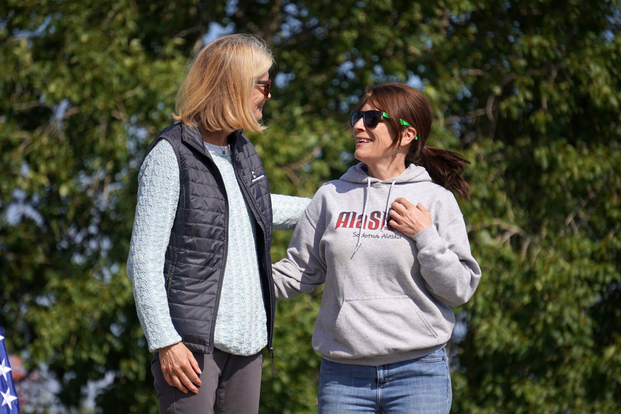 Sara Erickson, right, is greeted by Sen. Lisa Murkowki before receiving the Innovator Award for her business, AlaSkins, during Industry Appreciation Day festivities at the Kenai softball greenstrip on Saturday, Aug. 19, 2023. (Jake Dye/Peninsula Clarion)