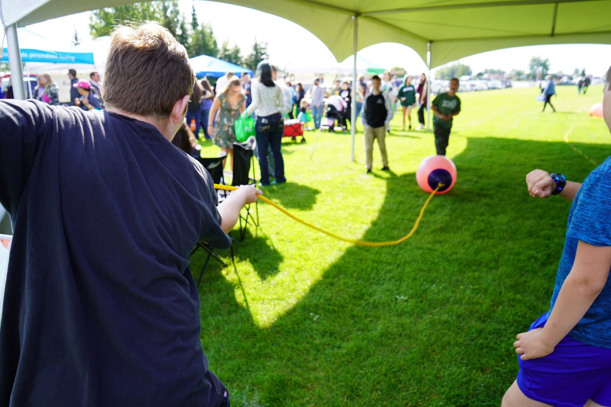 Bowe Meyers practices for the net pull competition, part of Industry Appreciation Day festivities at the Kenai softball greenstrip on Saturday, Aug. 19, 2023. (Jake Dye/Peninsula Clarion)