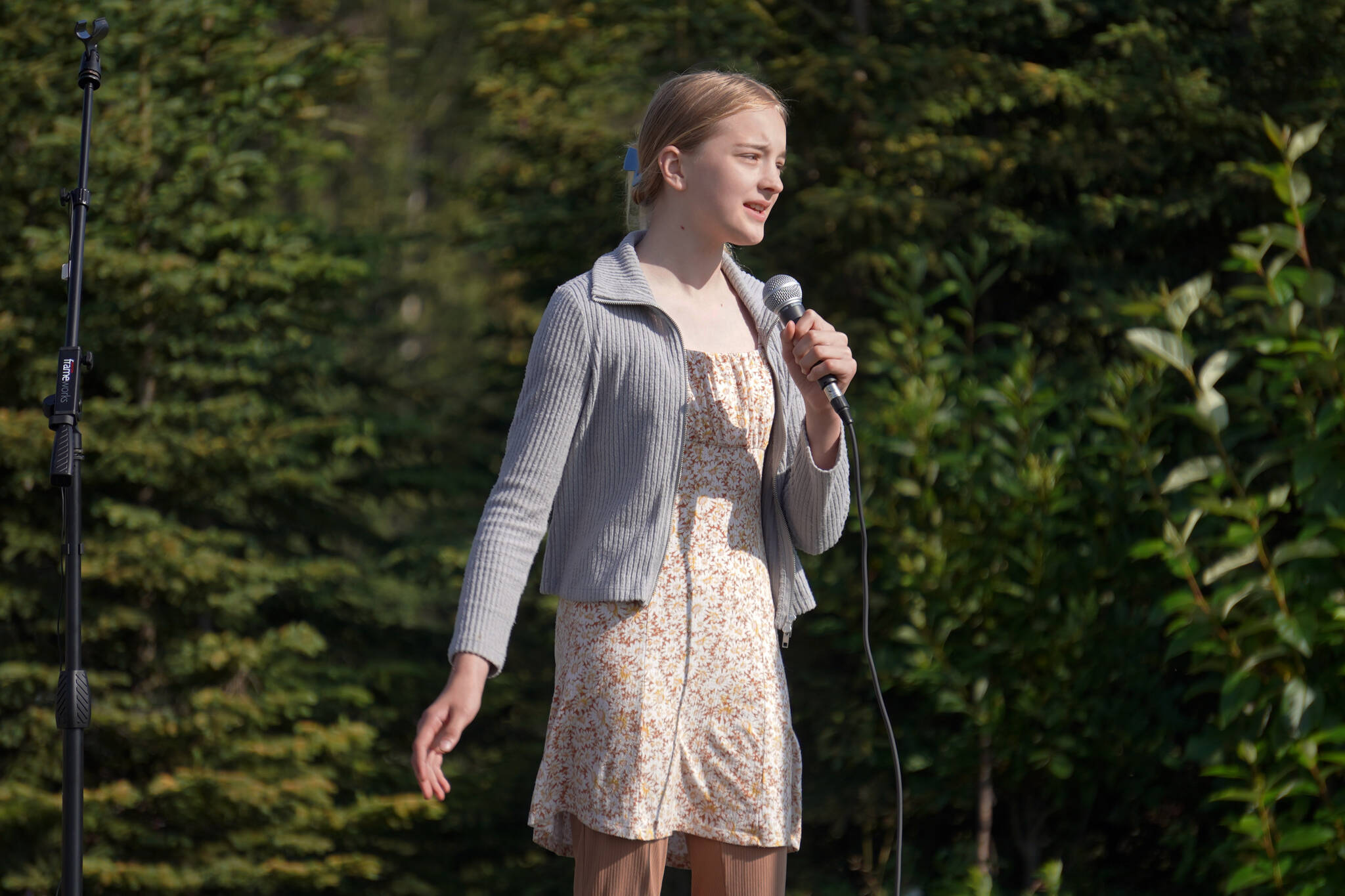 Sariah Henderson sings “Tomorrow” from “Annie” during a ceremonial groundbreaking for the future home of Triumvirate Theatre at Daubenspeck Family Park in Kenai, Alaska, on Saturday, Aug. 19, 2023. (Jake Dye/Peninsula Clarion)
