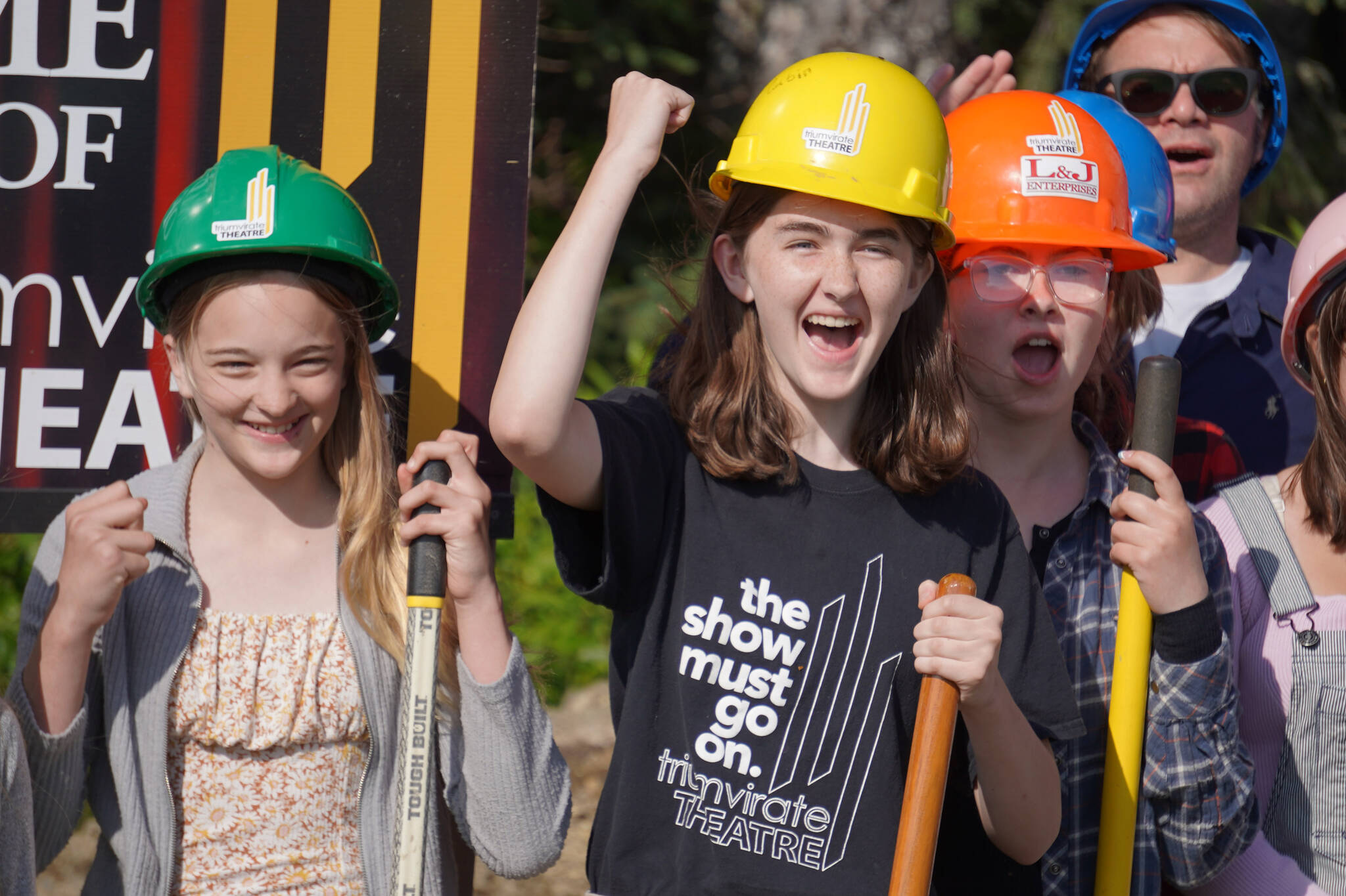 Triumvirate Theatre performers rally together at a ceremonial groundbreaking at the future home of Triumvirate Theatre in Kenai, Alaska, on Saturday, Aug. 19, 2023. (Jake Dye/Peninsula Clarion)