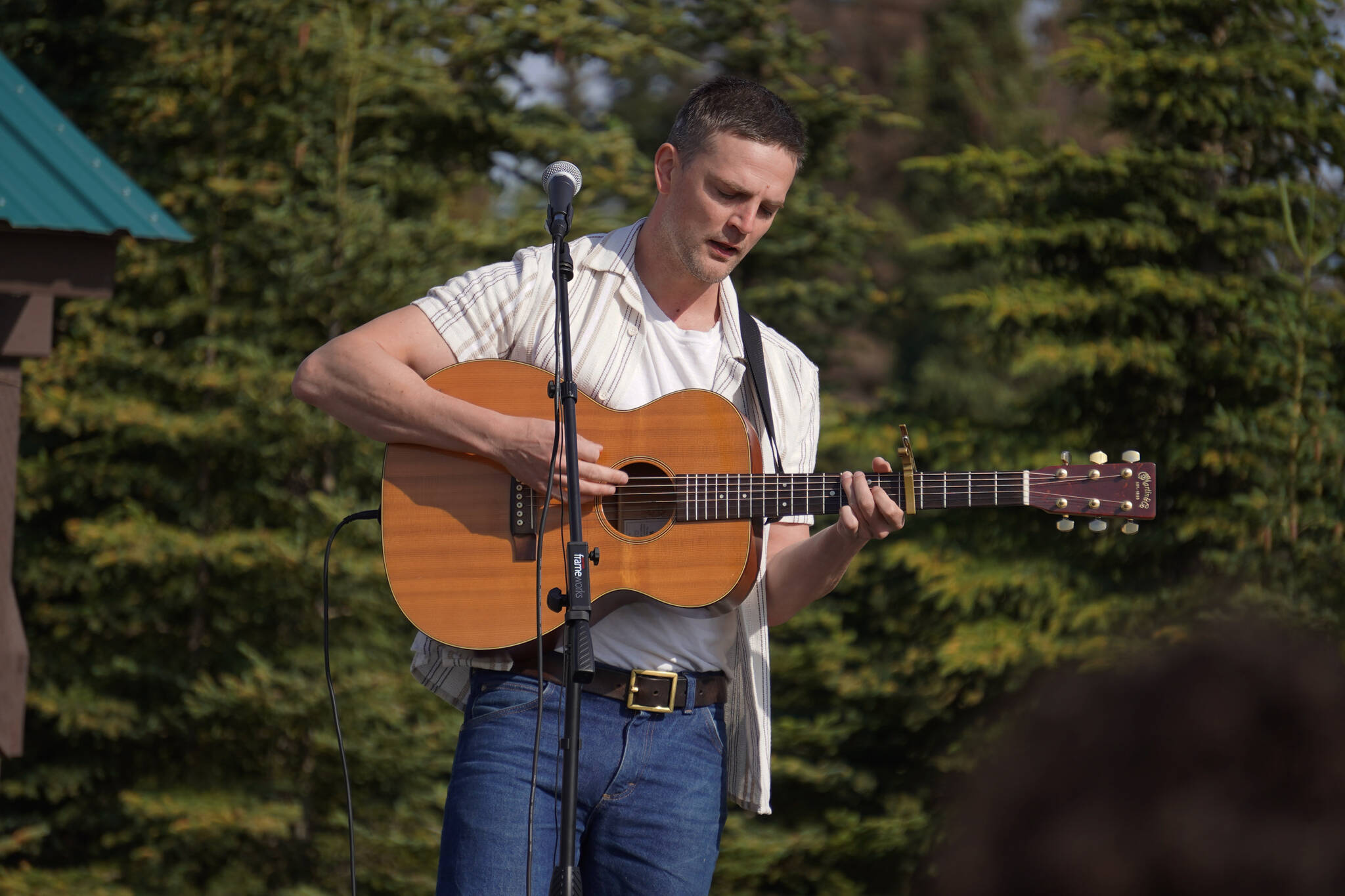 Jesse Tauriainen performs during a ceremonial groundbreaking for the future home of Triumvirate Theatre at Daubenspeck Family Park in Kenai, Alaska, on Saturday, Aug. 19, 2023. (Jake Dye/Peninsula Clarion)