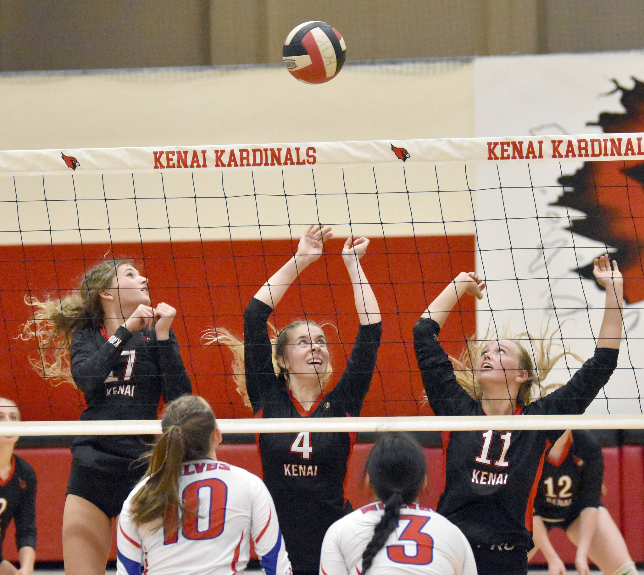 Kenai Central’s Sophie Tapley, Avia Miller and Grace Beiser put up a block against Sitka on Wednesday, Aug. 23, 2023, at Kenai Central High School in Kenai, Alaska. (Photo by Jeff Helminiak/Peninsula Clarion)