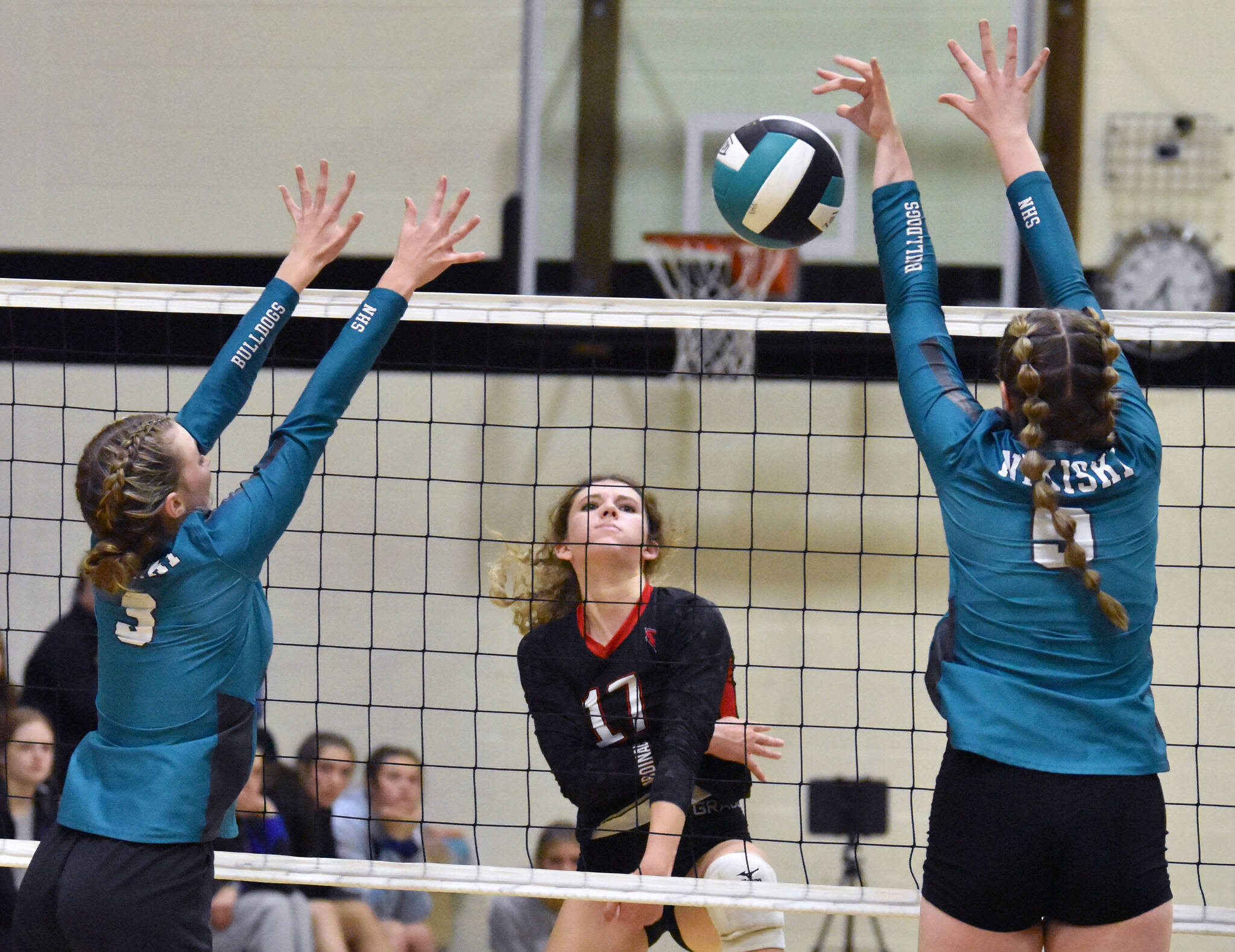 Kenai Central’s Sophia Tapley attacks against Nikiski’s Zoey Ellis and Ashlynne Playle on Saturday, Aug. 26, 2023, at the Shayna Pritchard Memorial Tournament at Nikiski Middle-High School in Nikiski, Alaska. (Photo by Jeff Helminiak/Peninsula Clarion)