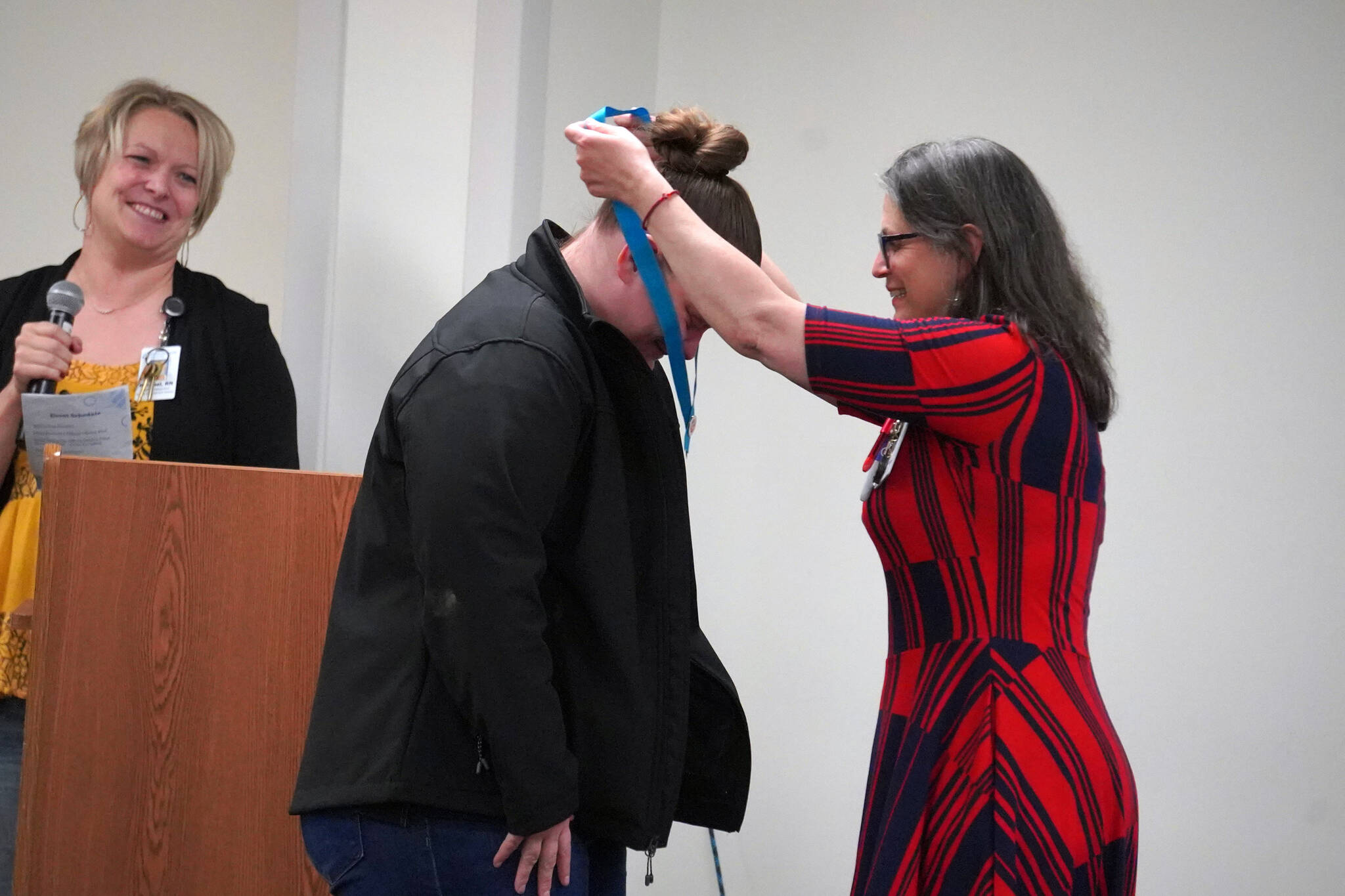Morgan Gillman receives a certified nurse assistant pin from Ana Monyahan at a CNA graduation ceremony at Central Peninsula Hospital in Soldotna, Alaska, on Friday, Aug. 25, 2023. (Jake Dye/Peninsula Clarion)