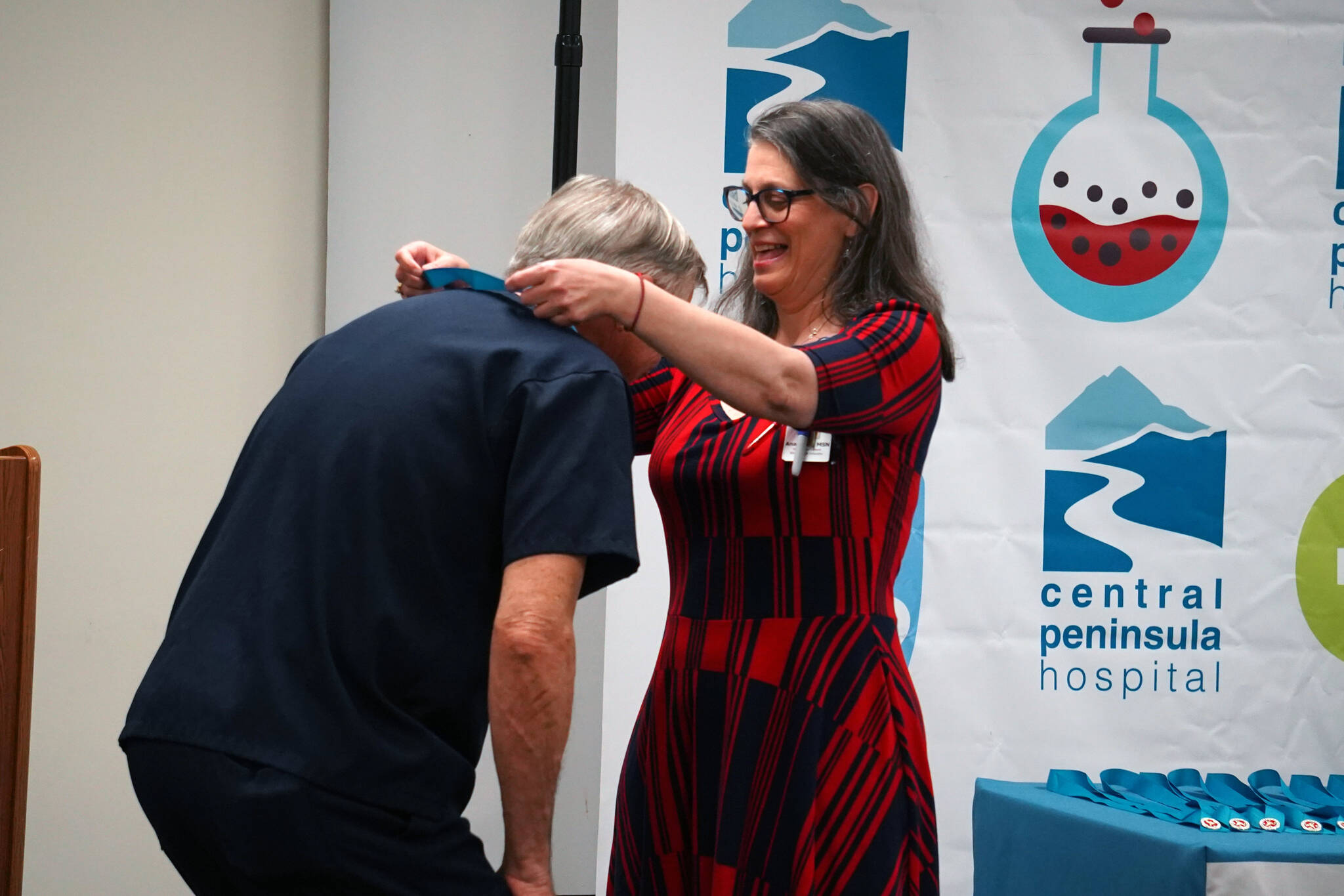Daniel Hicks receives his certified nurse assistant pin from Ana Monyahan at a CNA graduation ceremony at Central Peninsula Hospital in Soldotna, Alaska, on Friday, Aug. 25, 2023. (Jake Dye/Peninsula Clarion)