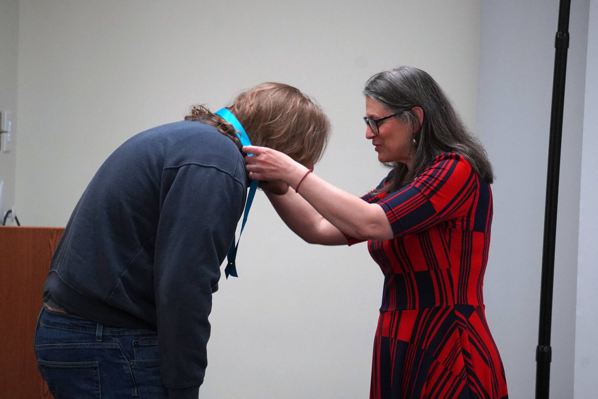 Robert McGinnis receives his certified nurse assistant pin from Ana Monyahan at a CNA graduation ceremony at Central Peninsula Hospital in Soldotna, Alaska, on Friday, Aug. 25, 2023. (Jake Dye/Peninsula Clarion)