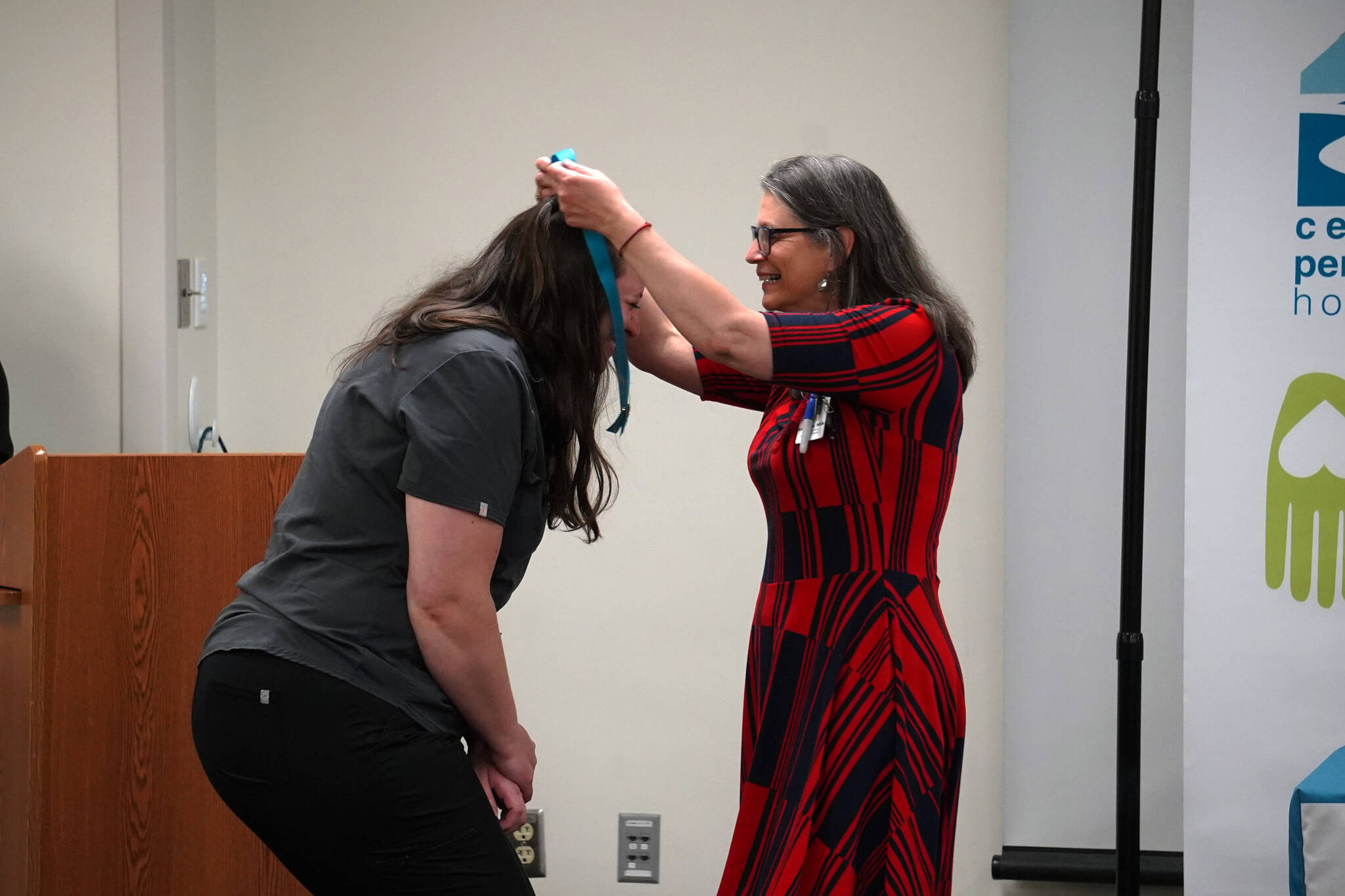 Jessica Reser receives a certified nurse assistant pin from Ana Monyahan at a CNA graduation ceremony at Central Peninsula Hospital in Soldotna, Alaska, on Friday, Aug. 25, 2023. (Jake Dye/Peninsula Clarion)
