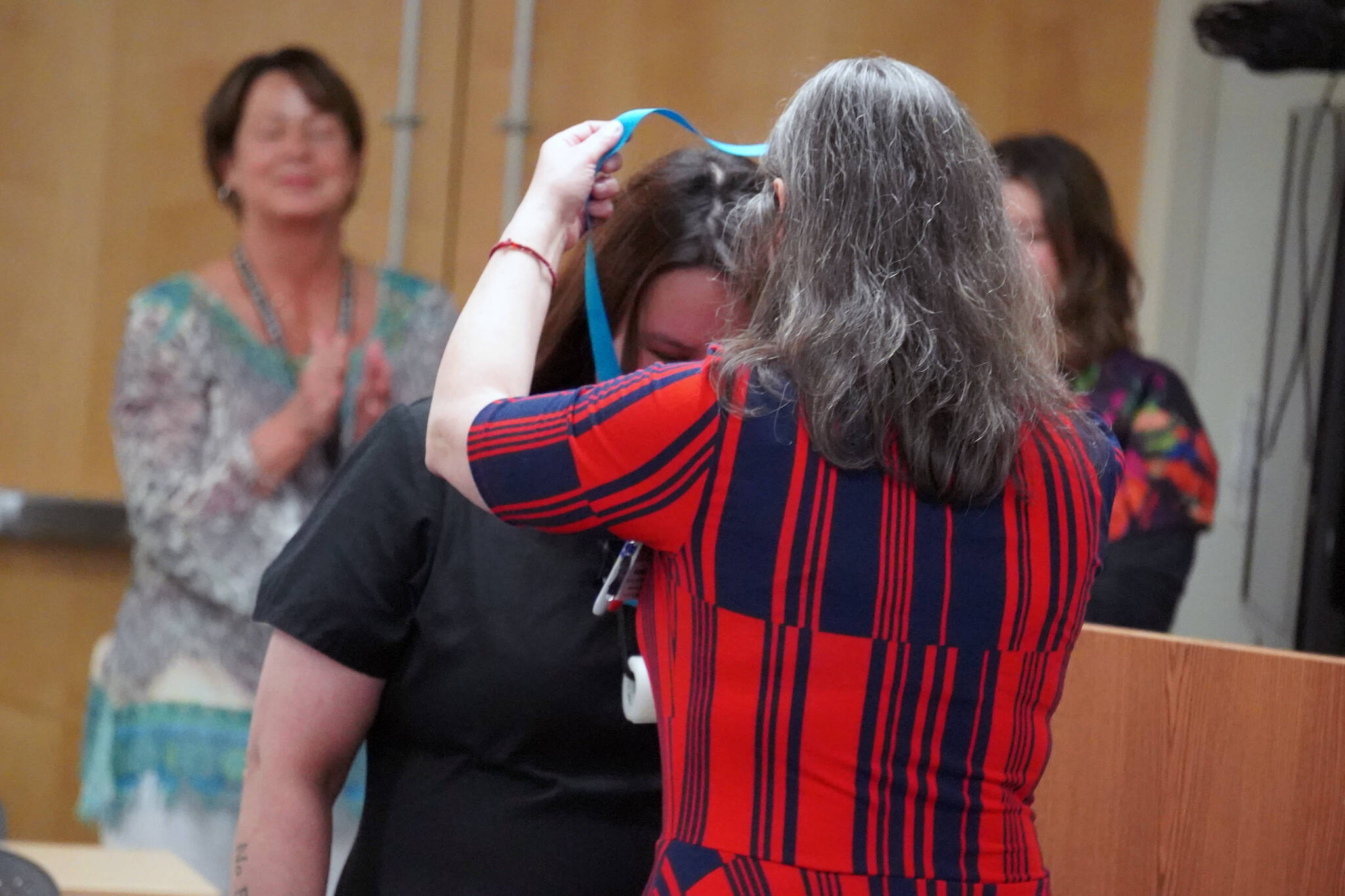 Jamie Childers receives a certified nurse assistant pin from Ana Monyahan at a CNA graduation ceremony at Central Peninsula Hospital in Soldotna, Alaska, on Friday, Aug. 25, 2023. (Jake Dye/Peninsula Clarion)