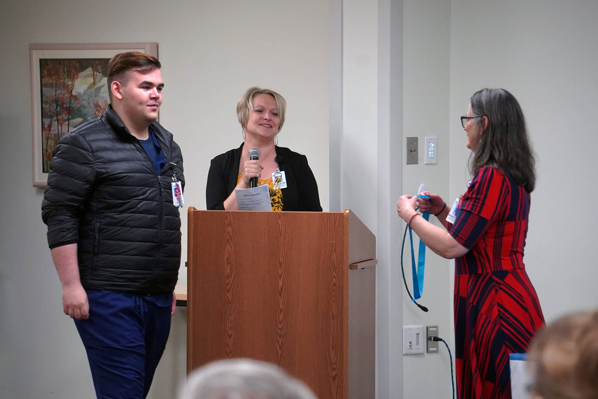 Kenneth Coghill II receives a certified nurse assistant pin from Ana Monyahan at a CNA graduation ceremony at Central Peninsula Hospital in Soldotna, Alaska, on Friday, Aug. 25, 2023. (Jake Dye/Peninsula Clarion)