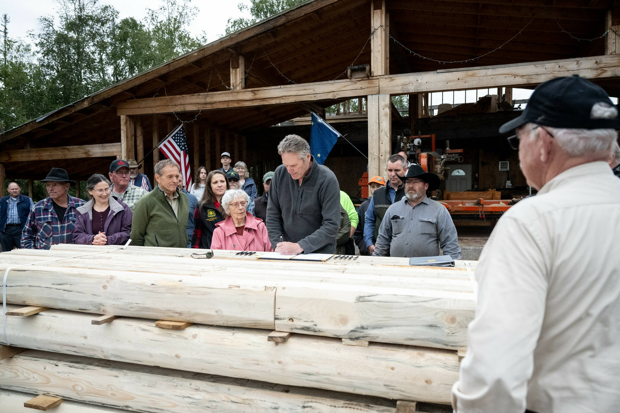 Gov. Mike Dunleavy signs S.B. 7 into law at Papoose Milling on Wednesday, Aug. 30, 2023, in Big Lake, Alaska. (Photo courtesy Gov. Mike Dunleavy’s Office)
