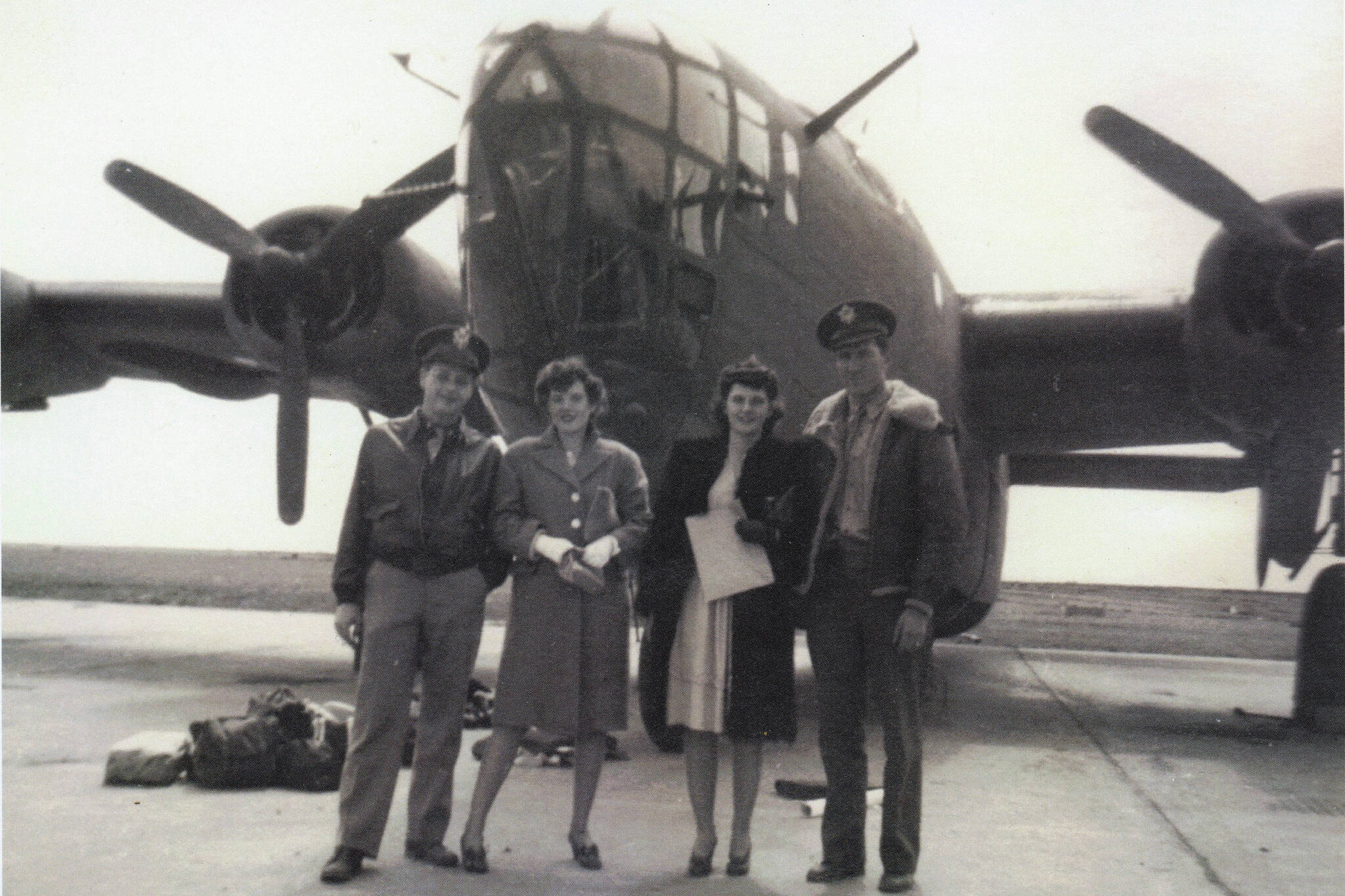 [   2a—] Larry and Rusty Lancashire (at left) pose in front of a B-24 bomber in the early 1940s with another unidentified couple. Larry was a B-24 co-pilot during World War II. (Photo courtesy of the Lancashire Family Collection)
