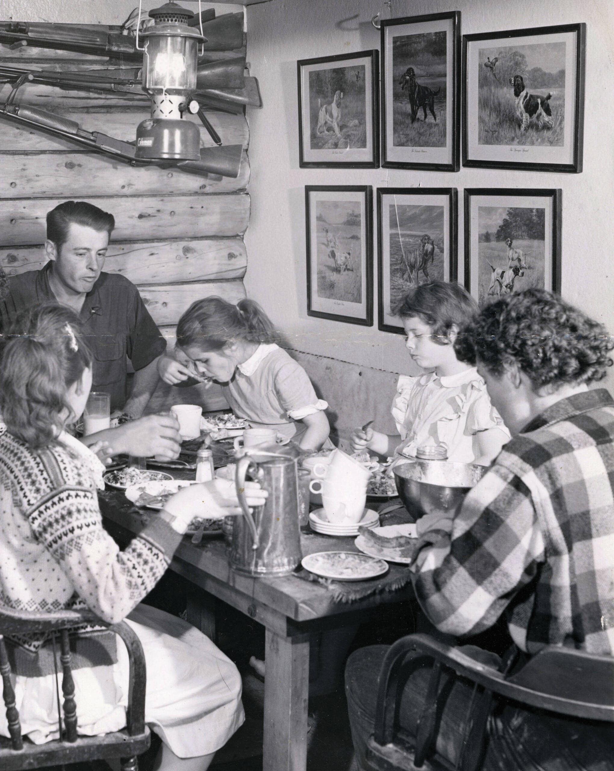 The Lancashire family shares a meal in their original homestead cabin. (1954 photo by Bob and Ira Spring for Better Homes & Garden magazine)