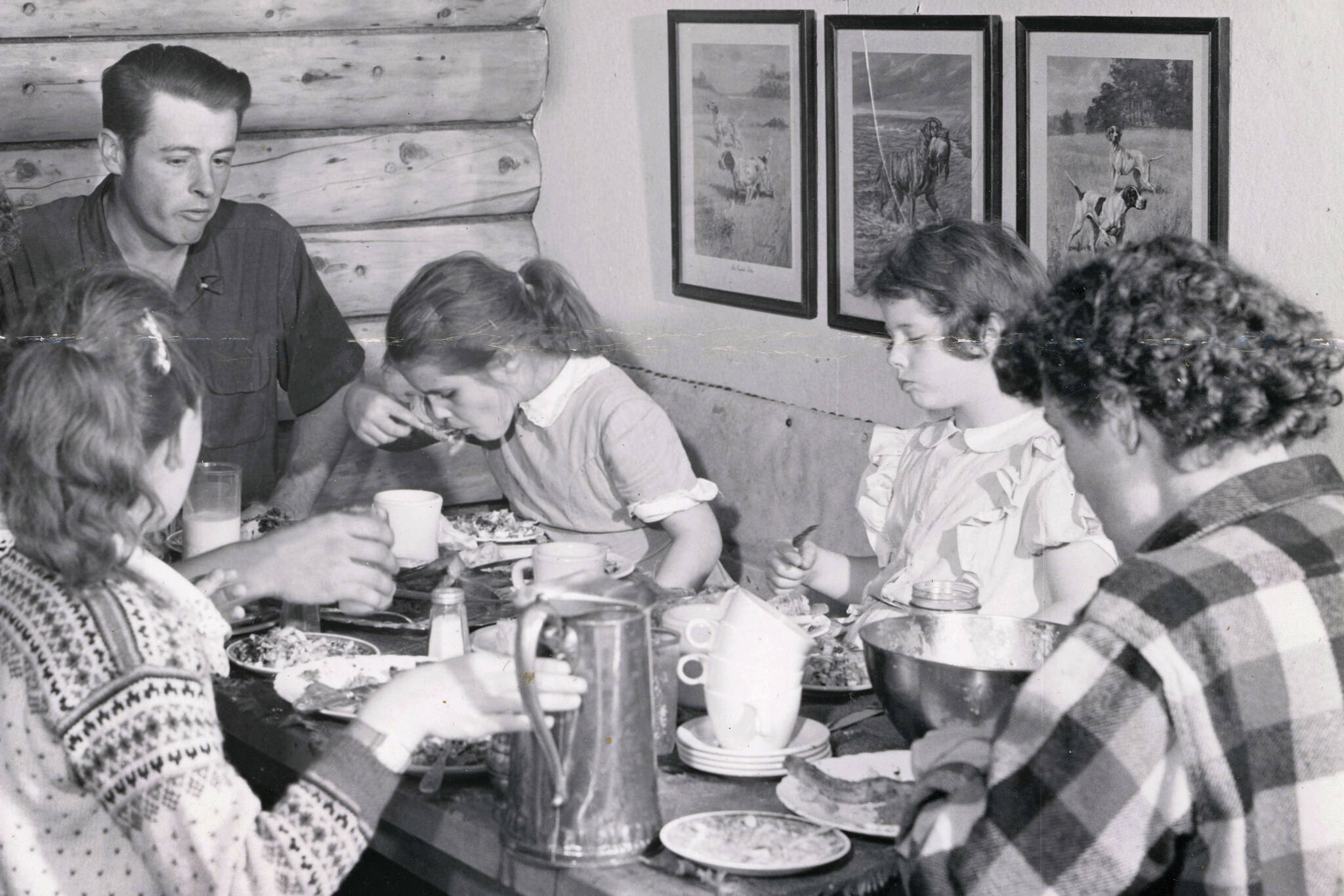 The Lancashire family shares a meal in their original homestead cabin. (1954 photo by Bob and Ira Spring for Better Homes & Garden magazine)