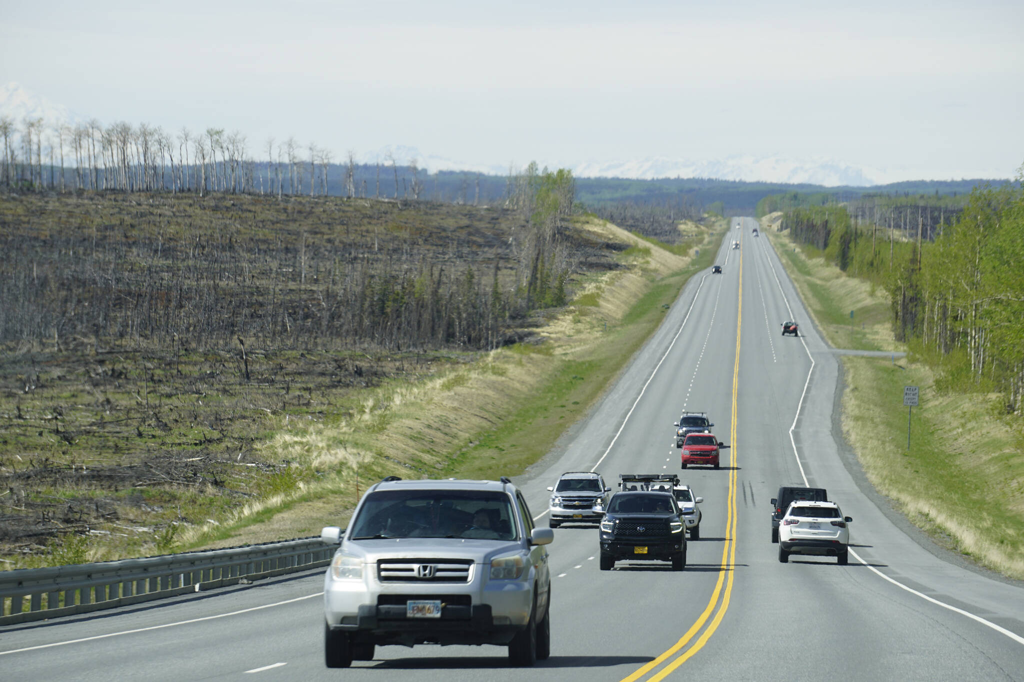 The Sterling Highway cuts through areas of the Kenai National Wildlife Refuge where burns from the Swan Lake can be seen, Sunday, May 22, 2022. (Photo by Michael Armstrong/Homer News)