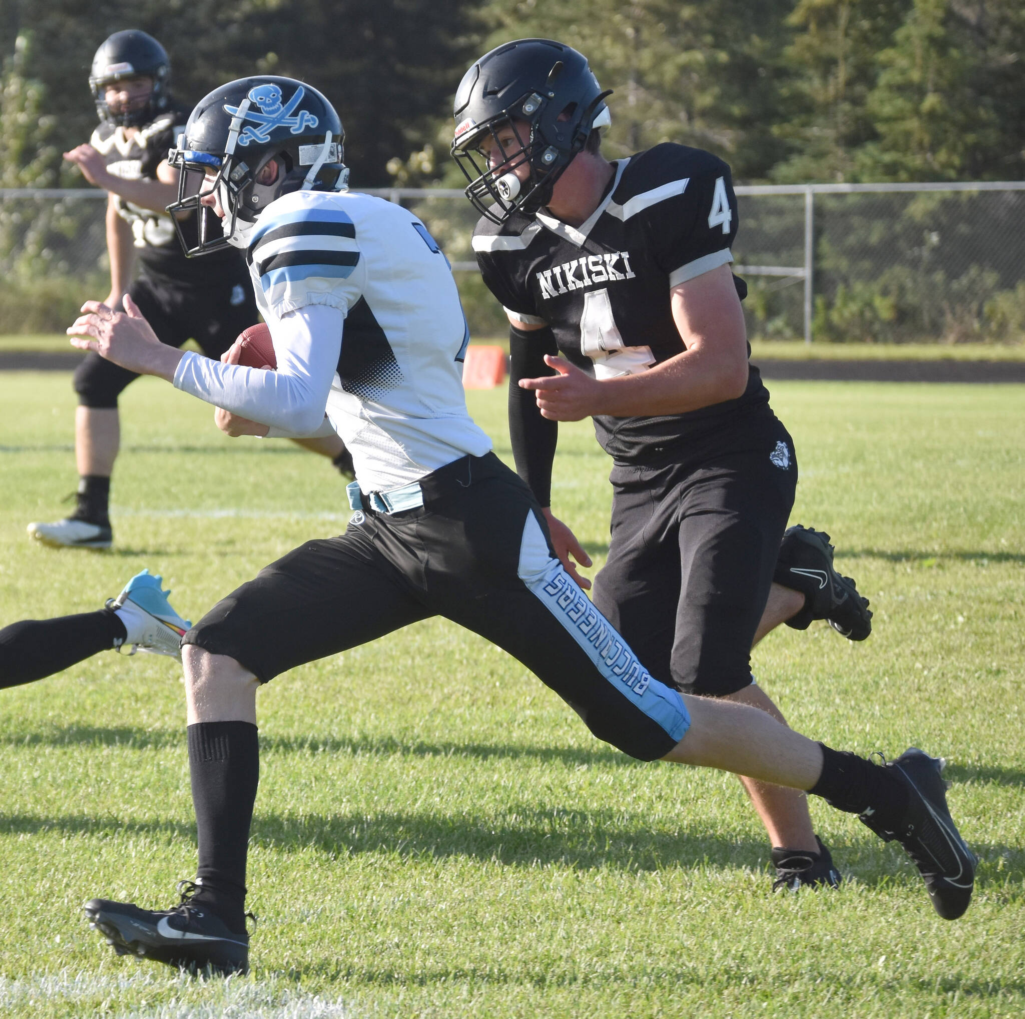Nikiski’s Oliver Parrish chases Valdez quarterback Barrett McCumby on Friday, Sept. 1, 2023, at Nikiski Middle-High School in Nikiski, Alaska. (Photo by Jeff Helminiak/Peninsula Clarion)