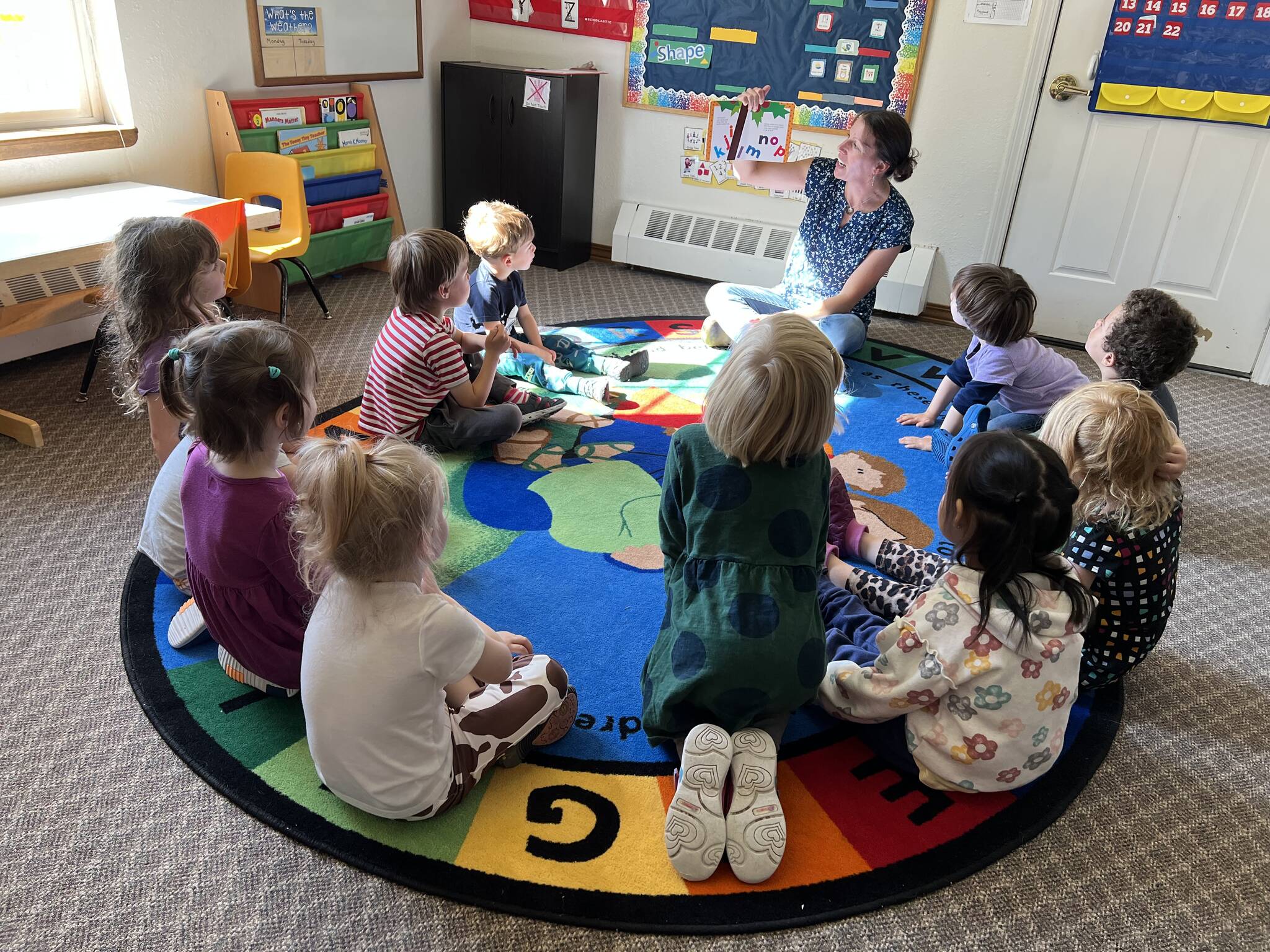Christy Phillips reads to preschoolers at Seward Sprouts Preschool in Seward, Alaska. (Photo courtesy Seward Sprouts Preschool)