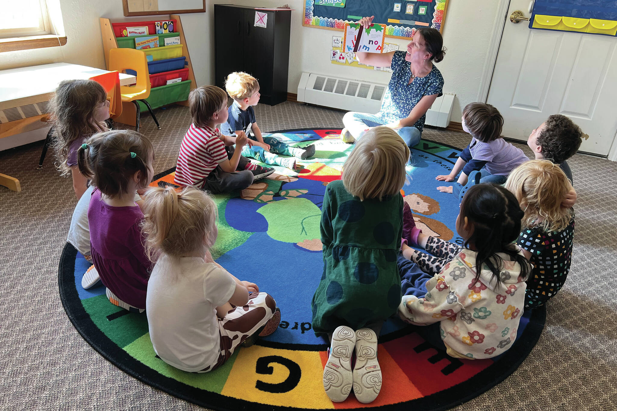 Christy Phillips reads to preschoolers at Seward Sprouts Preschool in Seward, Alaska. (Photo courtesy Seward Sprouts Preschool)