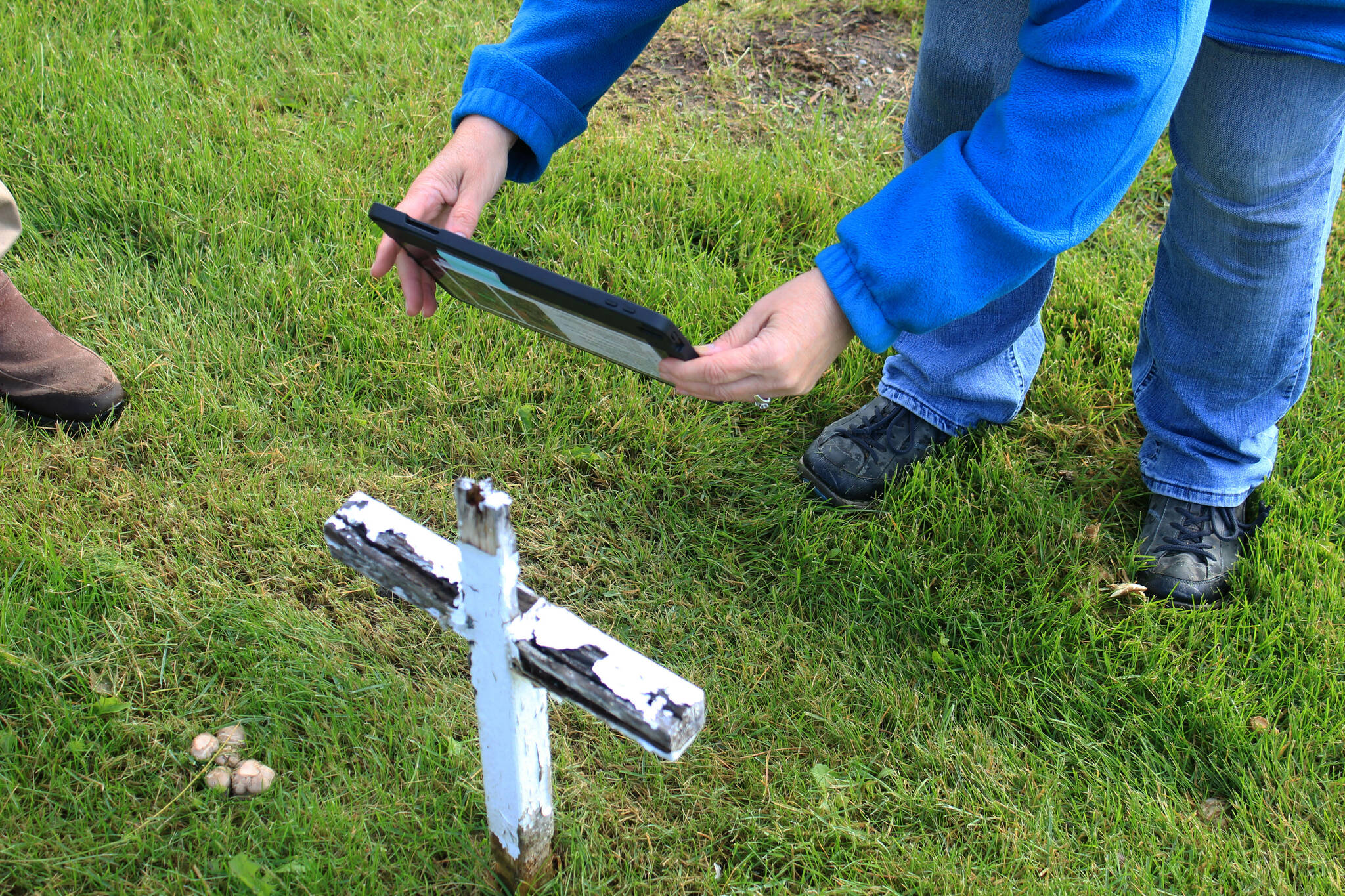 Victoria Askin photographs a gravemarker in the Kenai Cemetery as part of a city imaging project on Friday, Sept. 8, 2023 in Kenai, Alaska. (Ashlyn O’Hara/Peninsula Clarion)