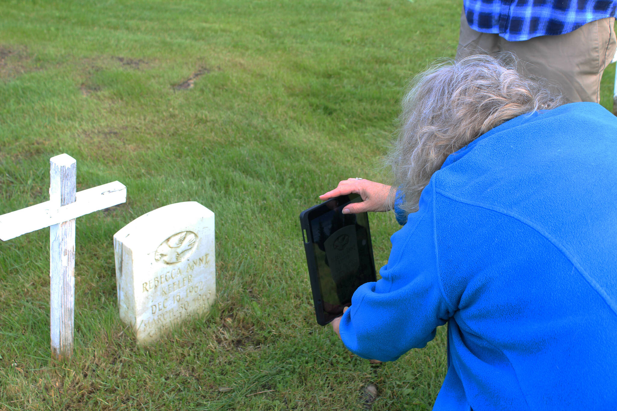 Victoria Askin photographs a headstone in the Kenai Cemetery as part of a city imaging project on Friday, Sept. 8, 2023 in Kenai, Alaska. (Ashlyn O’Hara/Peninsula Clarion)