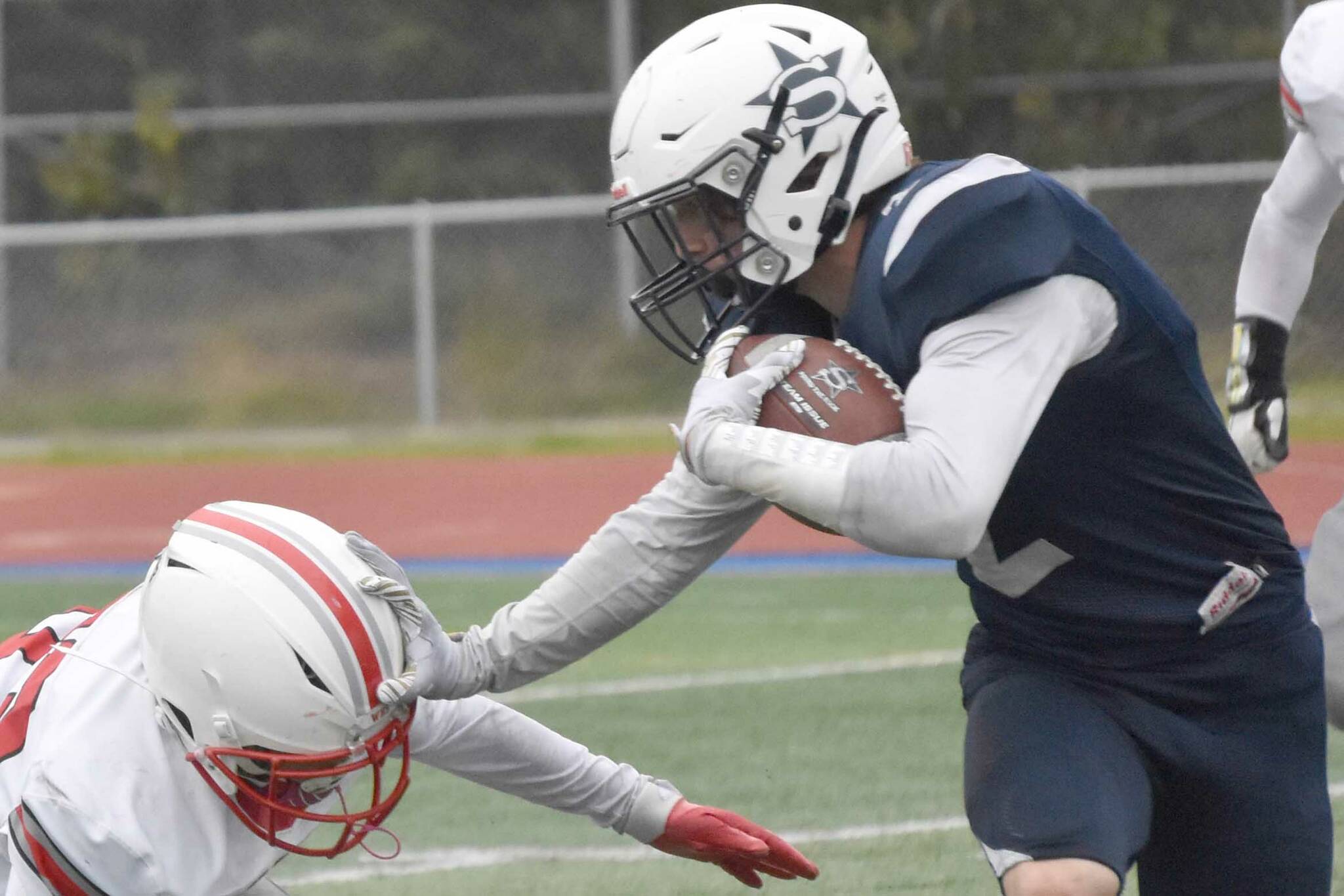 Soldotna's Leigh Tacey tries to avoid Wasilla's Kemeul Rodriguez on Friday, Sept. 8, 2023, at Justin Maile Field at Soldotna High School in Soldotna, Alaska. (Photo by Jeff Helminiak/Peninsula Clarion)