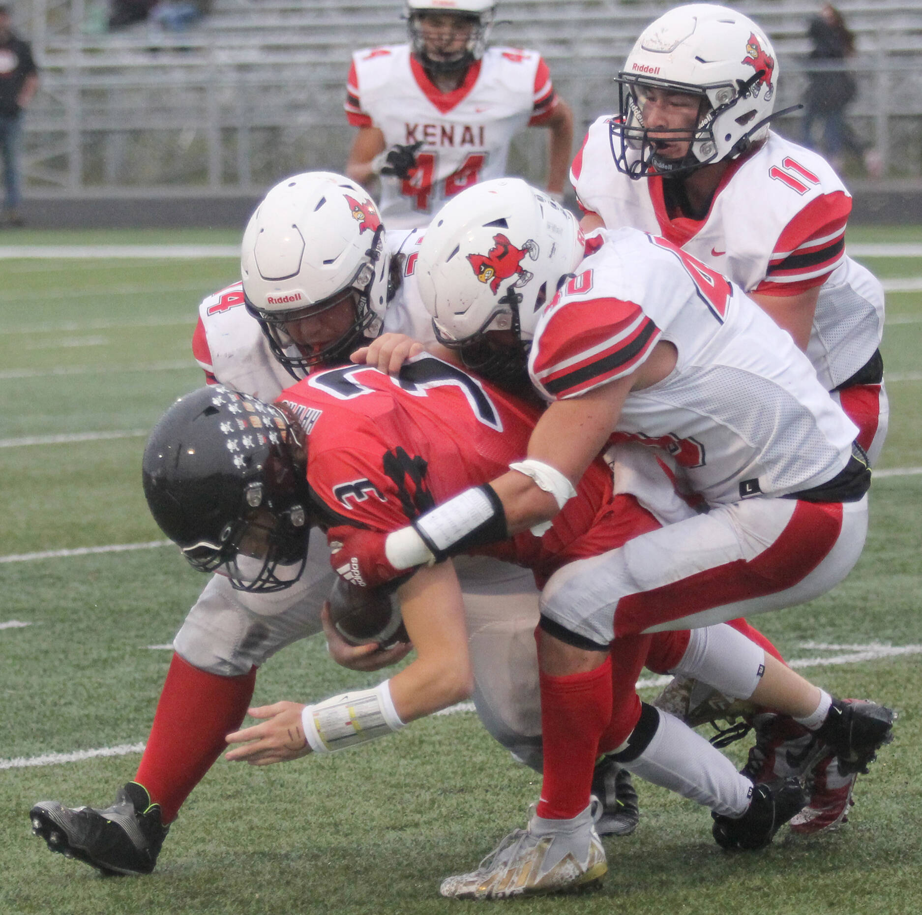 Kenai Centralճ Bobby Hayes leads a tackle of Houston quarterback Carter Seime during a 14-13 loss to Houston on Friday Sept. 8, 2023, in Houston. (Photo by Jeremiah Bartz/Frontiersman)