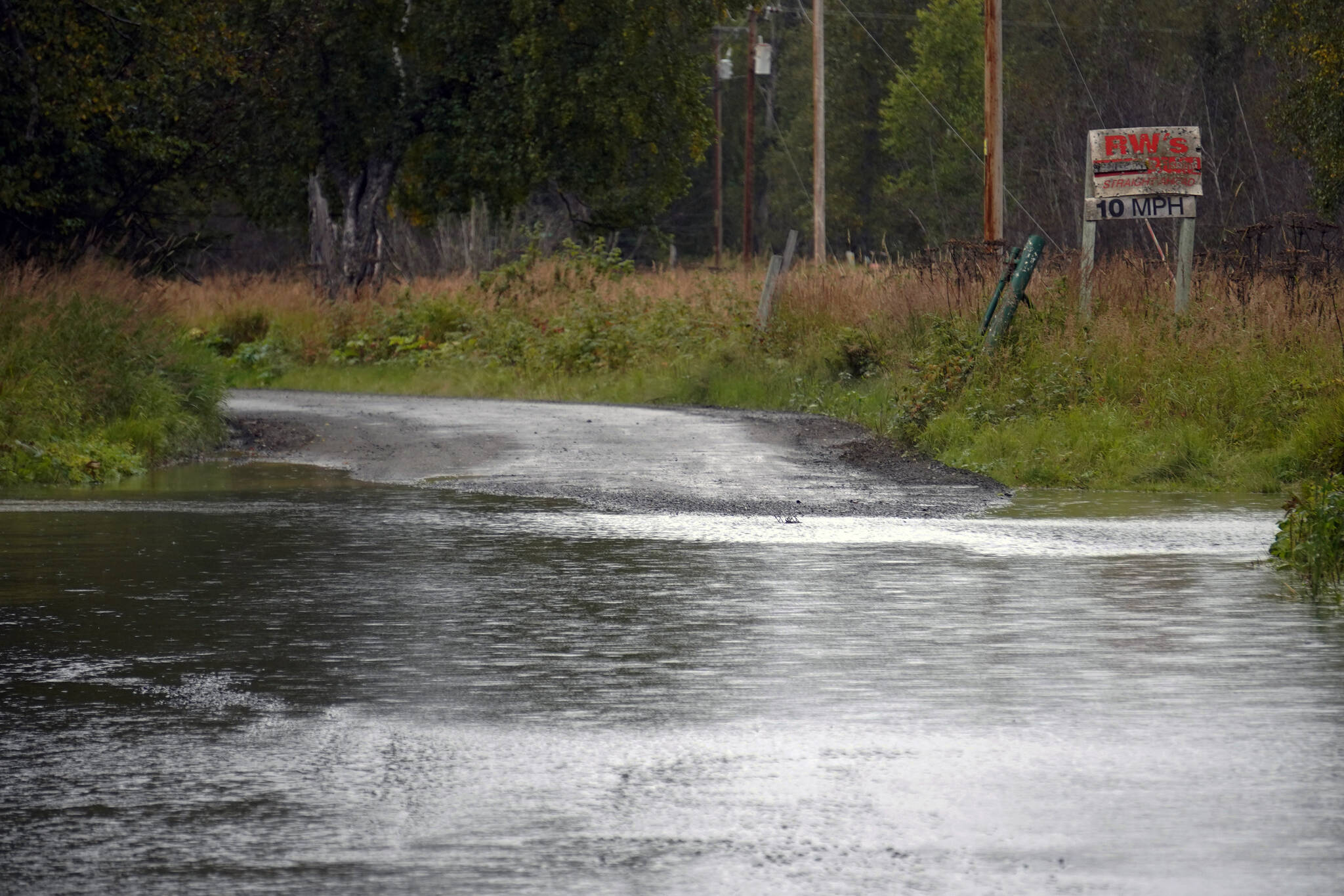 Water runs over Big Eddy Road in Soldotna, Alaska, on Tuesday, Sept. 12, 2023. (Jake Dye/Peninsula Clarion)