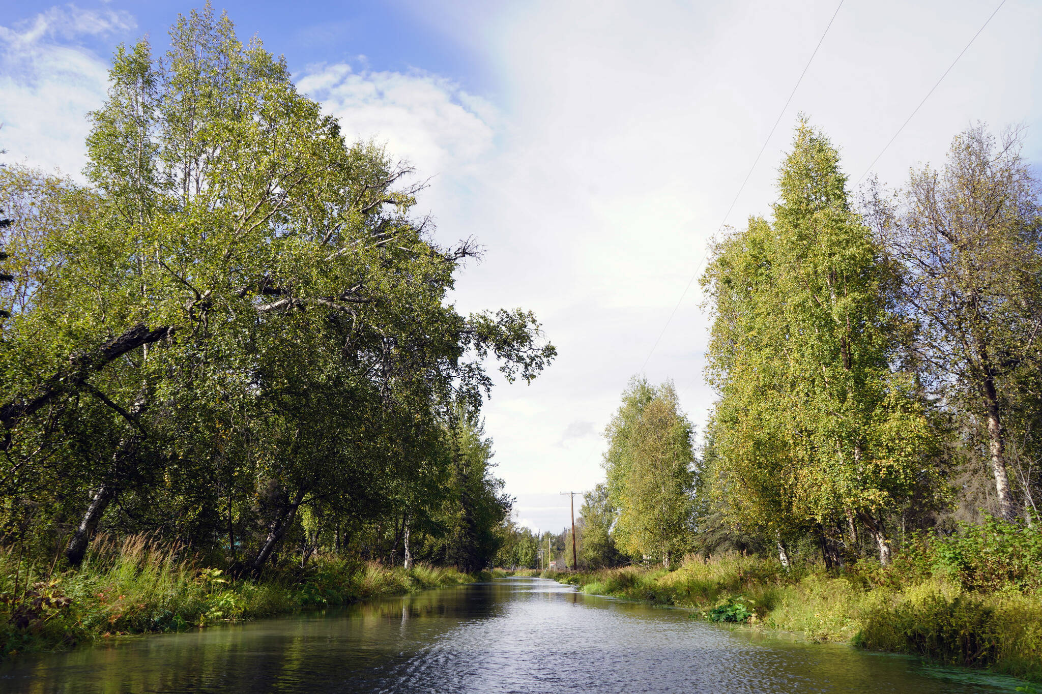 Water flows over Big Eddy Road in Soldotna, Alaska, on Wednesday, Sept. 13, 2023. (Jake Dye/Peninsula Clarion)