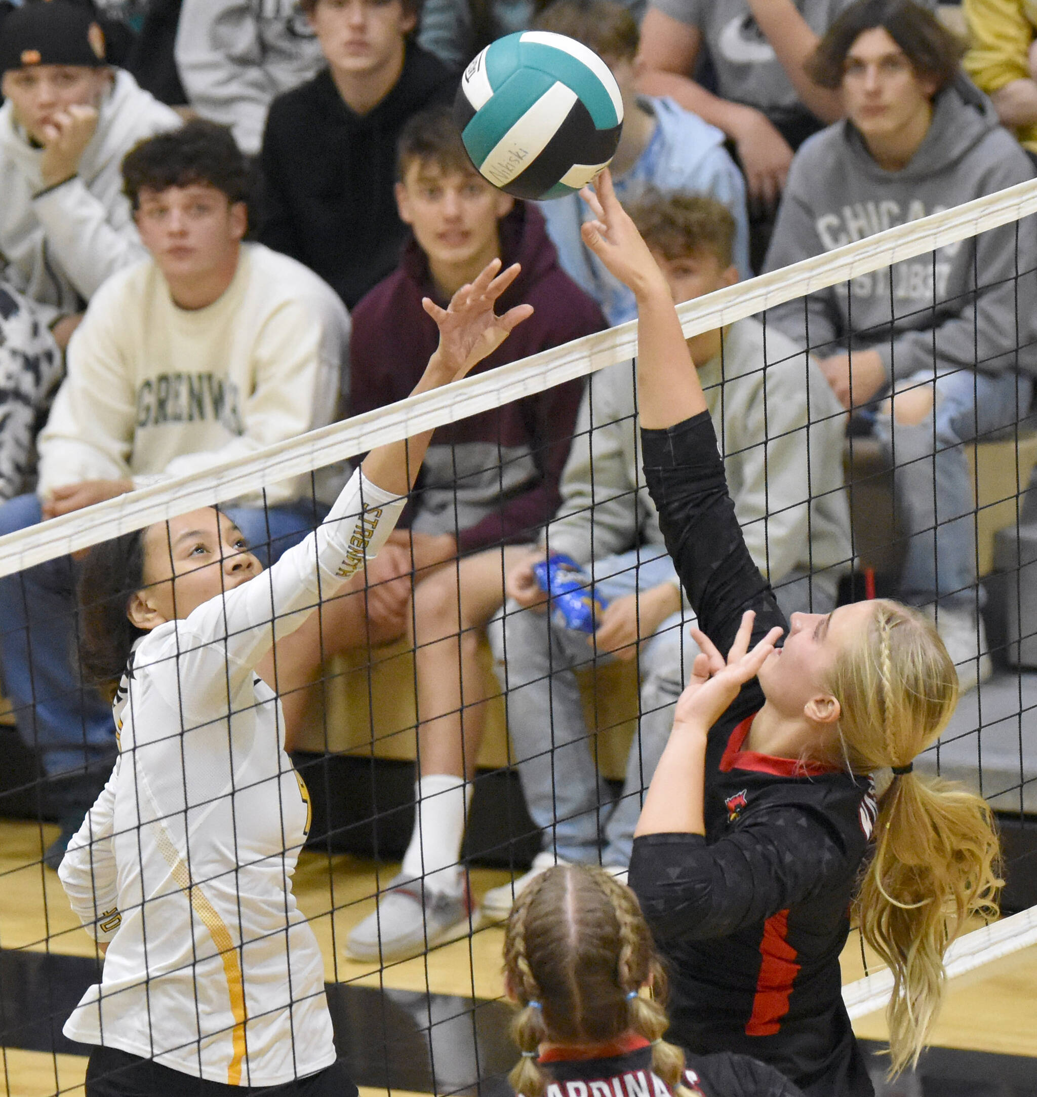 Nikiski’s Alexa Iyatunguk and Kenai Central’s Kate Wisnewski joust for the ball Thursday, Sept. 14, 2023, at Nikiski Middle-High School in Nikiski, Alaska. (Photo by Jeff Helminiak/Peninsula Clarion)
