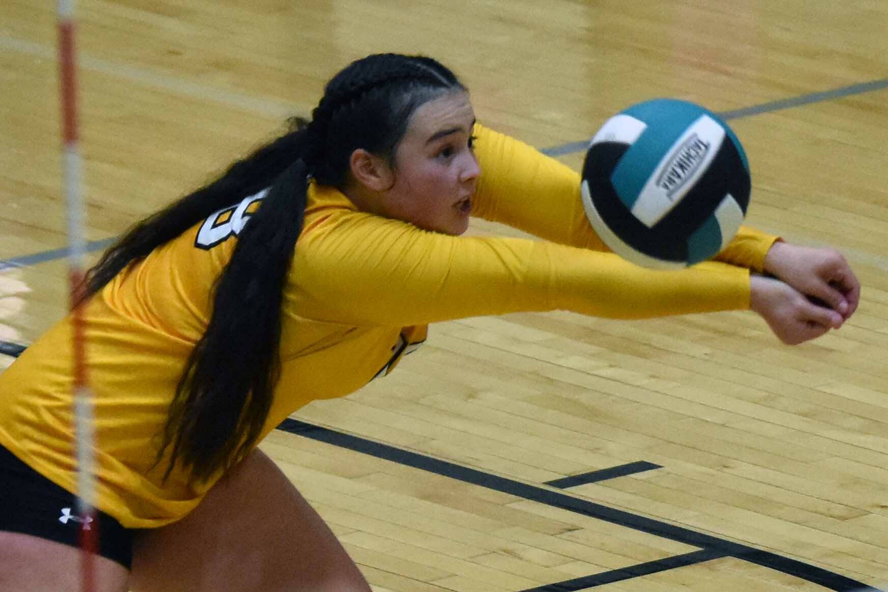 Nikiski's Kailey Stynsberg digs up a ball Thursday, Sept. 14, 2023, against Kenai Central at Nikiski Middle-High School in Nikiski, Alaska. (Photo by Jeff Helminiak/Peninsula Clarion)