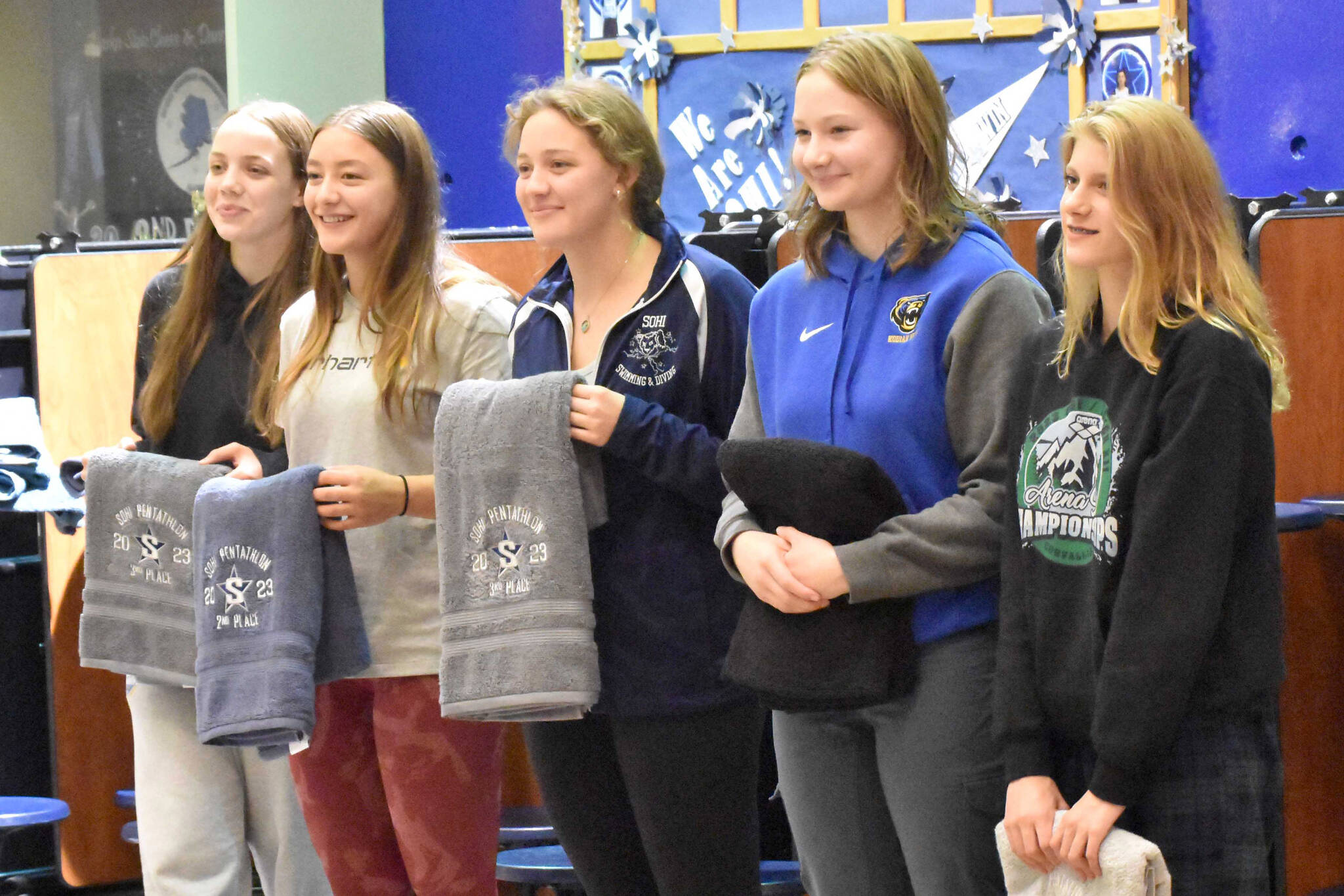 The top five girls finishers in the SoHi Pentathlon pose with their trophy towels Friday, Sept. 15, 2023, at Soldotna High School in Soldotna, Alaska. From left to right are first-place finisher Amaya Rocheleau of Kodiak, Colony’s Jasmine Anderson in second, Soldotna’s Charisma Watkins in third, Kodiak’s Morgan Hagen in fifth and Colony’s Hannah Cooper in fourth. (Photo by Jeff Helminiak/Peninsula Clarion)