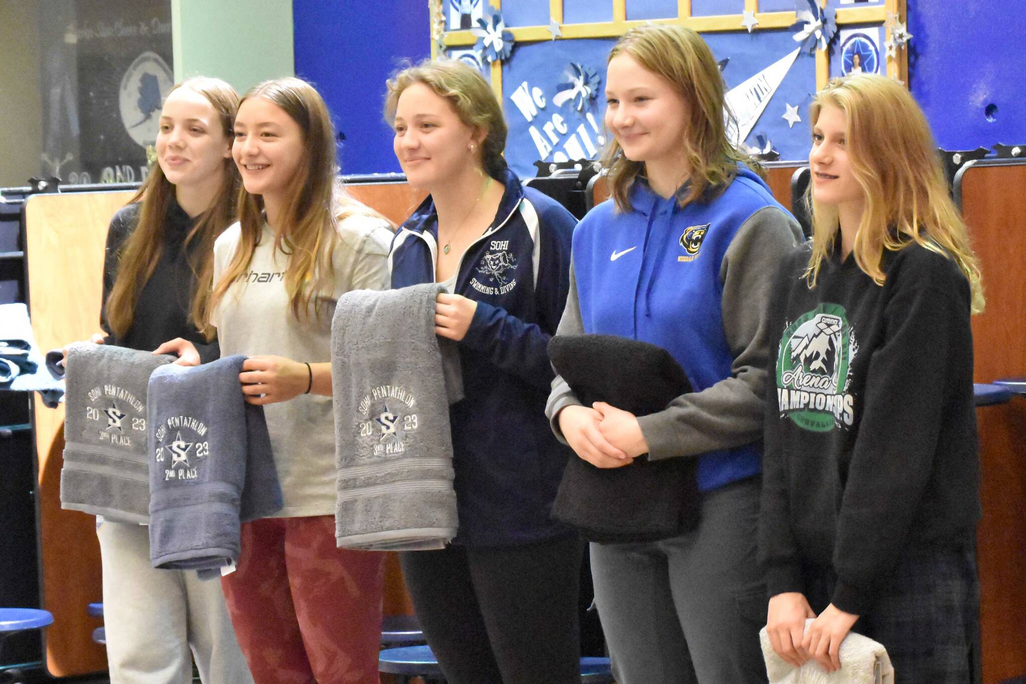 The top five finishers in the SoHi Pentathlon pose with their trophy towels Friday, Sept. 15, 2023, at Soldotna High School in Soldotna, Alaska. From left to right are first-place finisher Amaya Rocheleau of Kodiak, Colony's Jasmine Anderson in second, Soldotna's Charisma Watkins in third, Kodiak's Morgan Hagen in fifth and Colony's Hannah Cooper in fourth. (Photo by Jeff Helminiak/Peninsula Clarion)