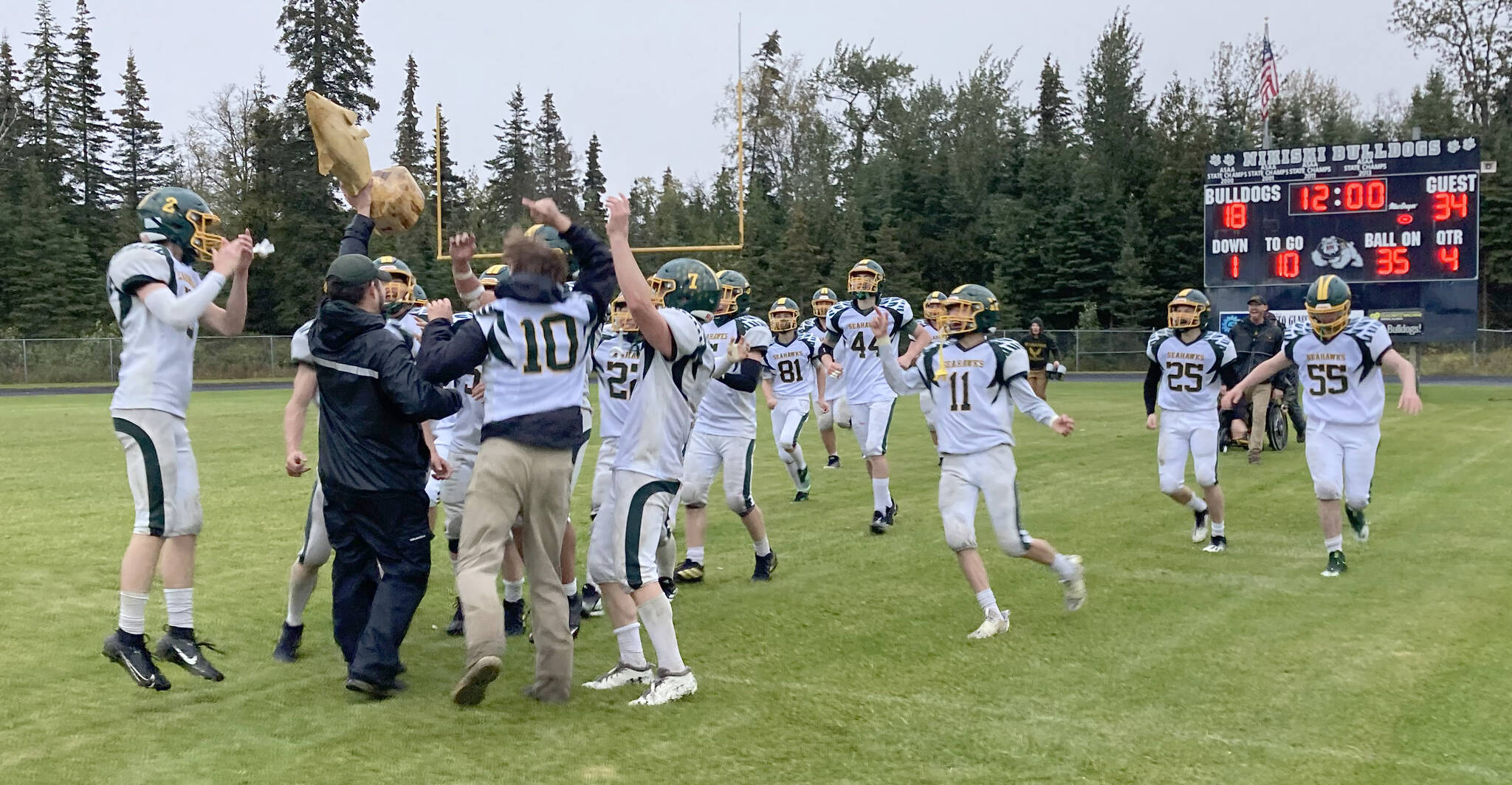 Seward head coach Tyler Mallory presents the Fish Bowl to his team after the Seahawks defeated Nikiski 34-18 on Saturday, Sept. 16, 2023, at Nikiski Middle-High School in Nikiski, Alaska. (Photo by Jeff Helminiak/Peninsula Clarion)