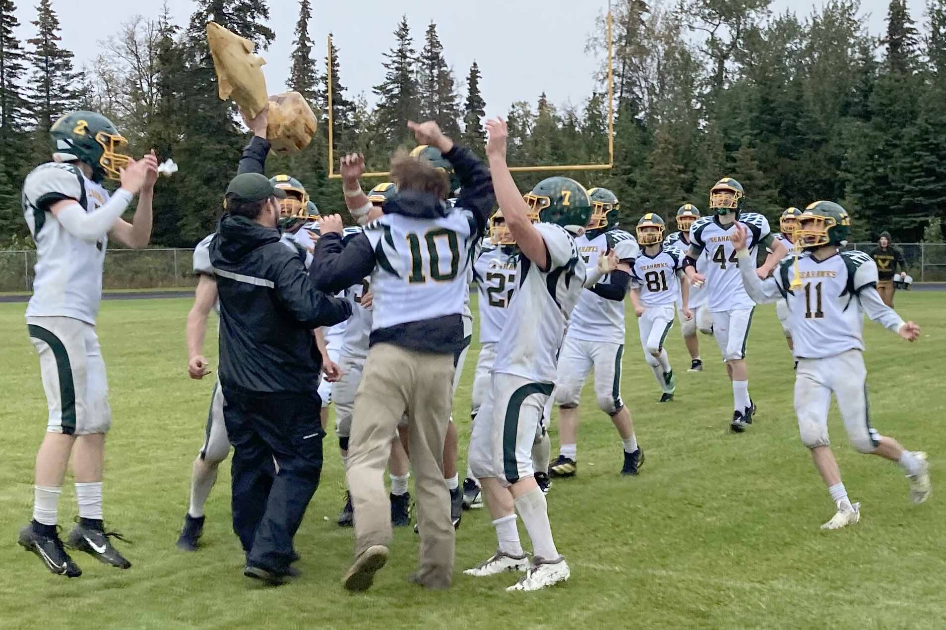 Seward head coach Tyler Mallory presents the Fish Bowl to his team after the Seahawks defeated Nikiski 34-18 on Saturday, Sept. 16, 2023, at Nikiski Middle-High School in Nikiski, Alaska. (Photo by Jeff Helminiak/Peninsula Clarion)