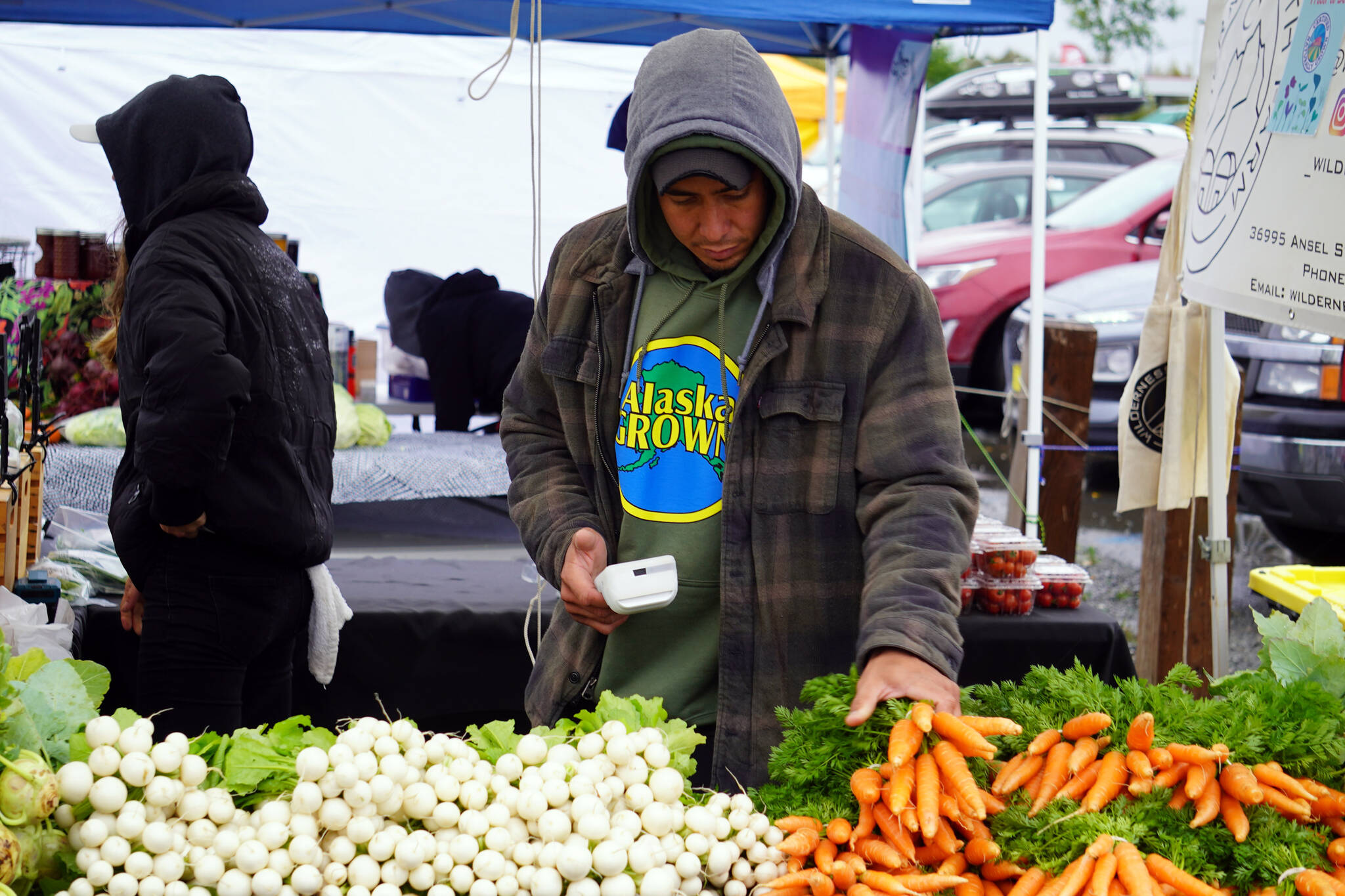 Fresh vegetables are sold at a booth by Wilderness Earth Farm during the Harvest Moon Local Food Festival at Soldotna Creek Park in Soldotna, Alaska, on Saturday, Sept. 16, 2023. (Jake Dye/Peninsula Clarion)
