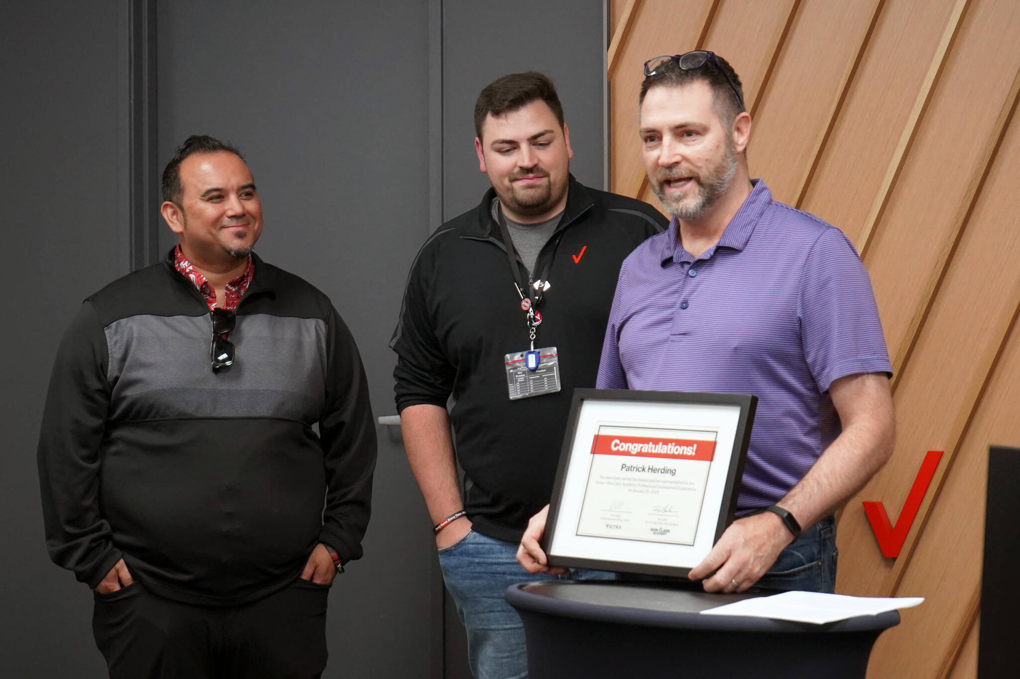 Skyview Middle School teacher Patrick Herding receives a certificate naming him the Alaska teacher representative for the Victra + Ron Clark Academy Professional Development Experience at the grand opening of Victra in Soldotna, Alaska, on Friday, Sept. 15, 2023. (Jake Dye/Peninsula Clarion)