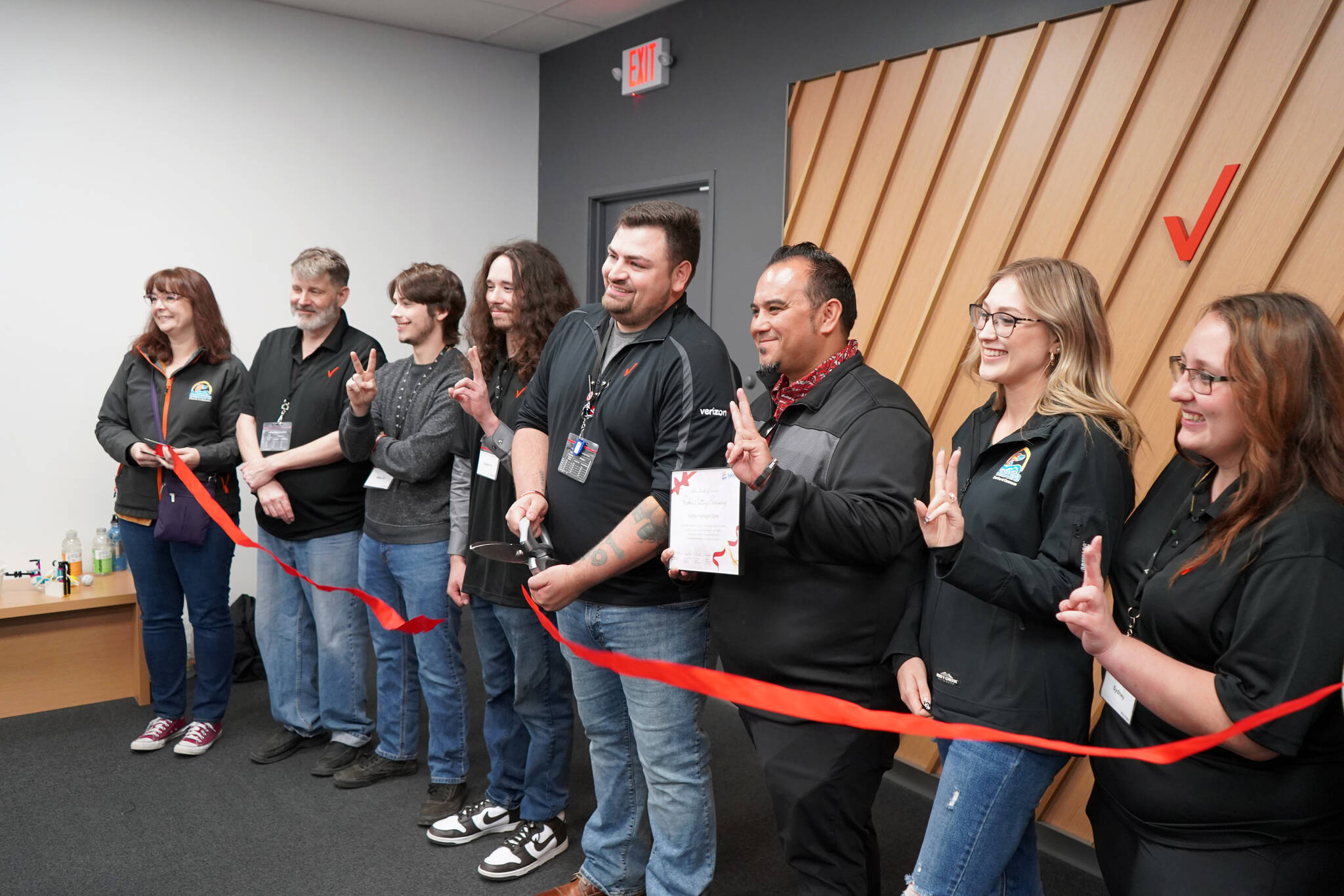 A ribbon is cut at the grand opening of the Victra in Soldotna, Alaska, on Friday, Sept. 15, 2023. (Jake Dye/Peninsula Clarion)