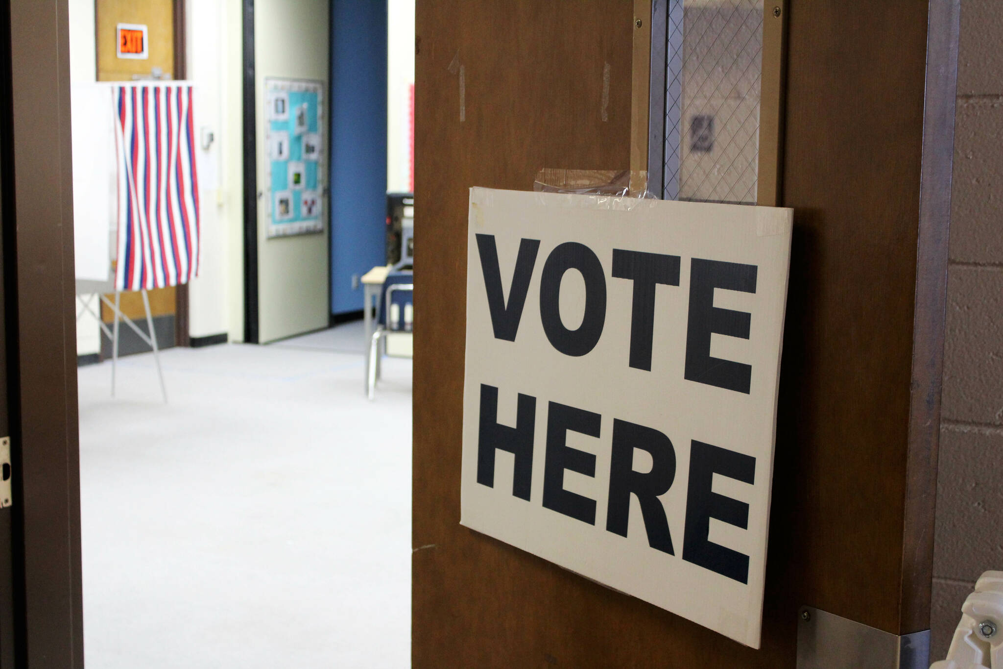 Signage directs voters to voting booths at Soldotna Prep School on Tuesday, Feb. 15, 2023, in Soldotna, Alaska. (Ashlyn O’Hara/Peninsula Clarion)