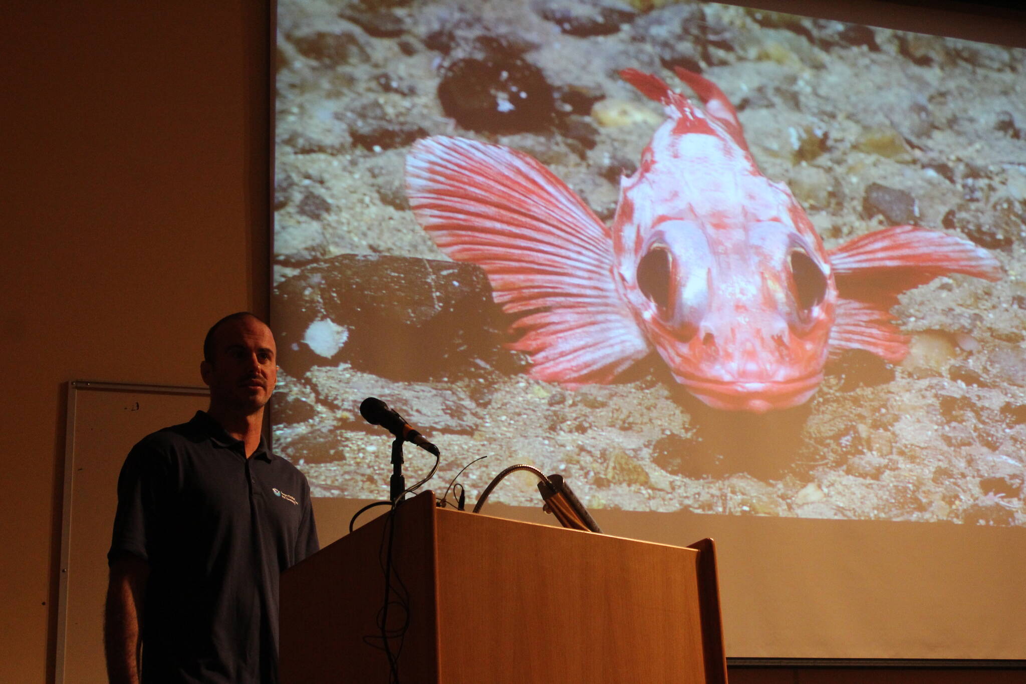 NOAA’s Sam Candio talks about research conducted aboard the Okeanos Explorer in Alaska this year during the inaugural Seward Marine Science Symposium on Sunday, Sept. 17, 2023, in Seward, Alaska. (Ashlyn O’Hara/Peninsula Clarion)