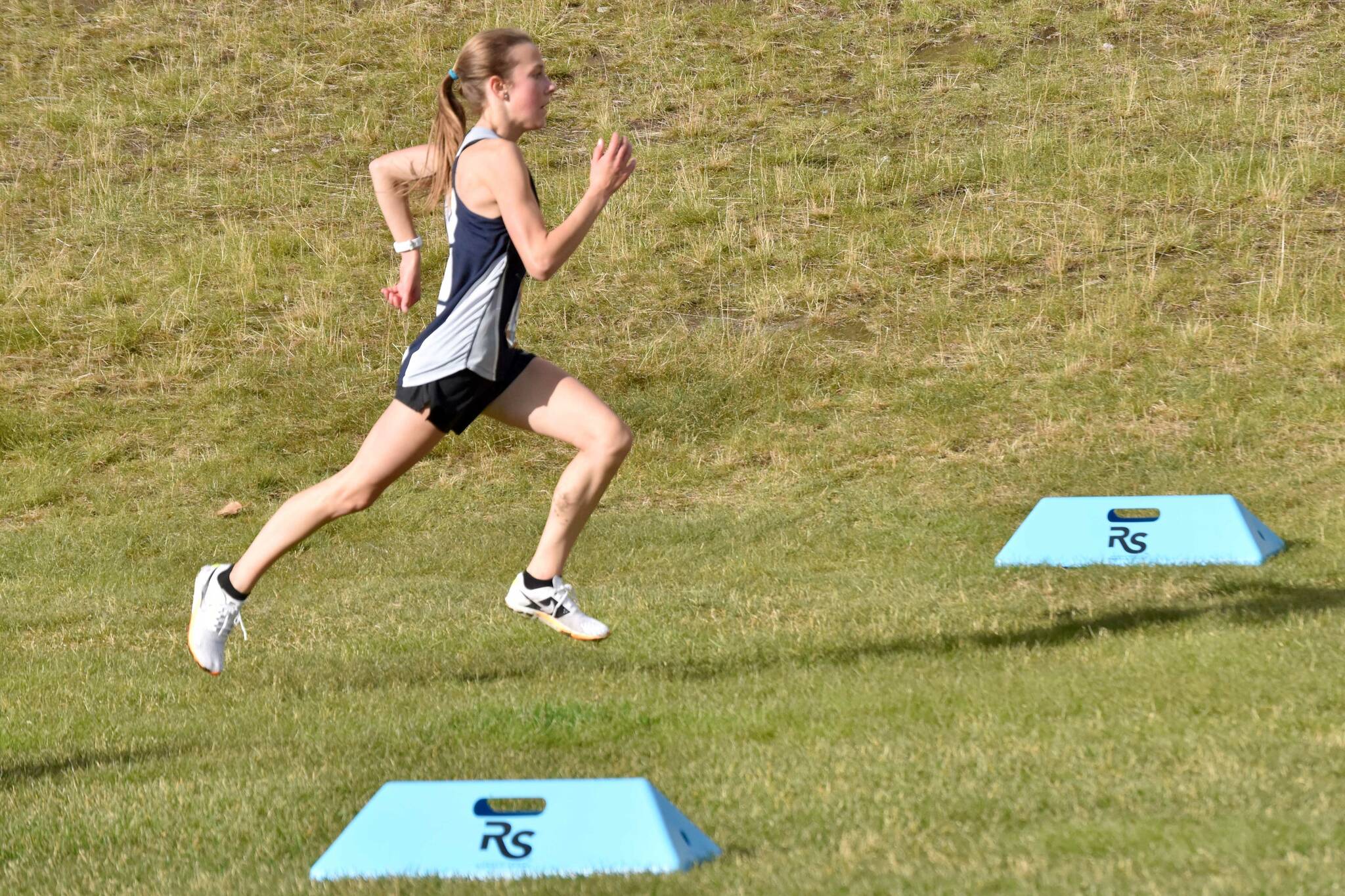 Soldotna's Tania Boonstra sprints to victory in the Kenai Peninsula Borough girls race Thursday, Sept. 21, 2023, at Tsalteshi Trails just outside of Soldotna, Alaska. (Photo by Jeff Helminiak/Peninsula Clarion)