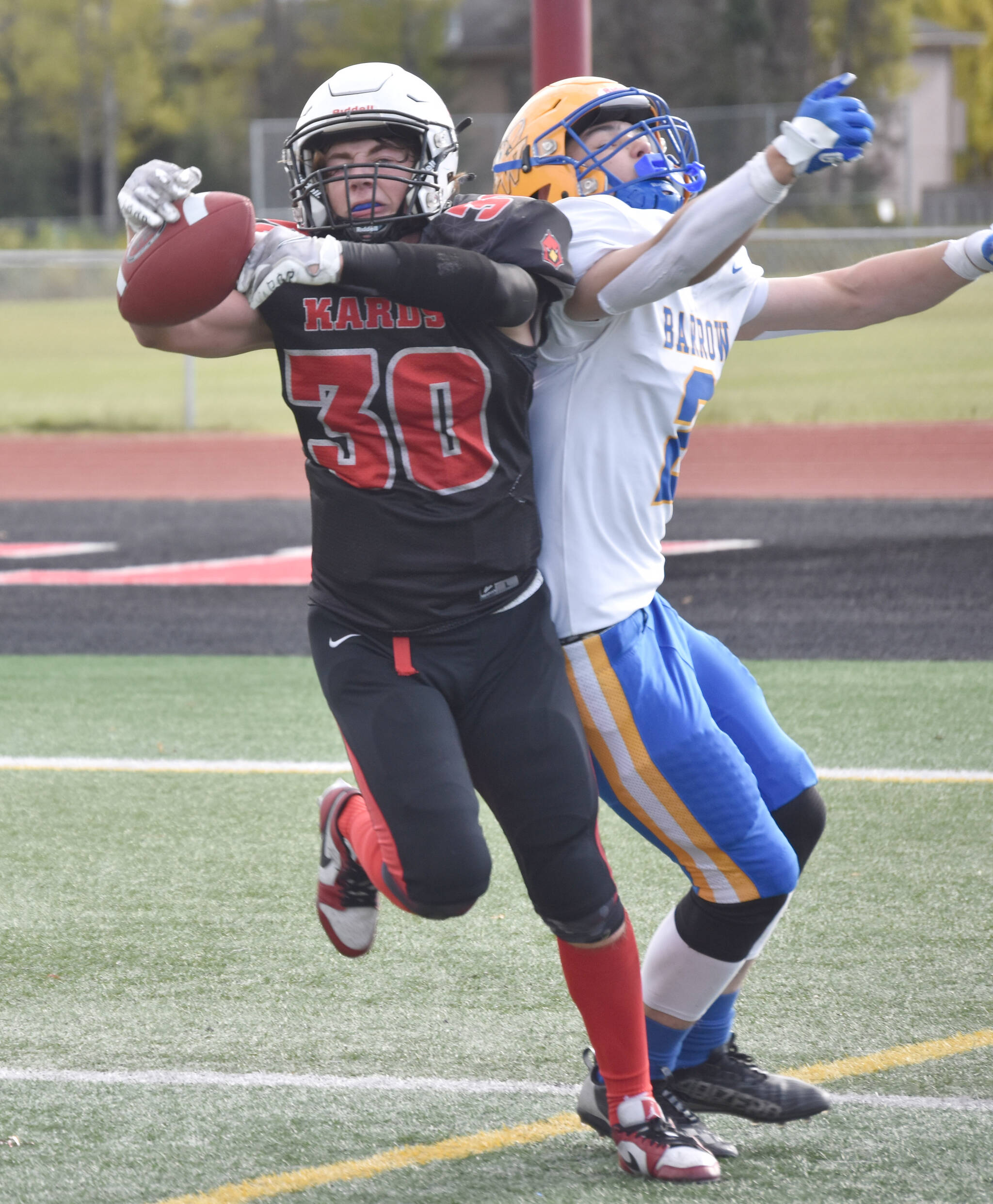 Kenai Central’s Cole Langham steps in front of Barrow’s Ethan Goodwin for an interception Saturday, Sept. 23, 2023, at Ed Hollier Field at Kenai Central High School in Kenai, Alaska. (Photo by Jeff Helminiak/Peninsula Clarion)