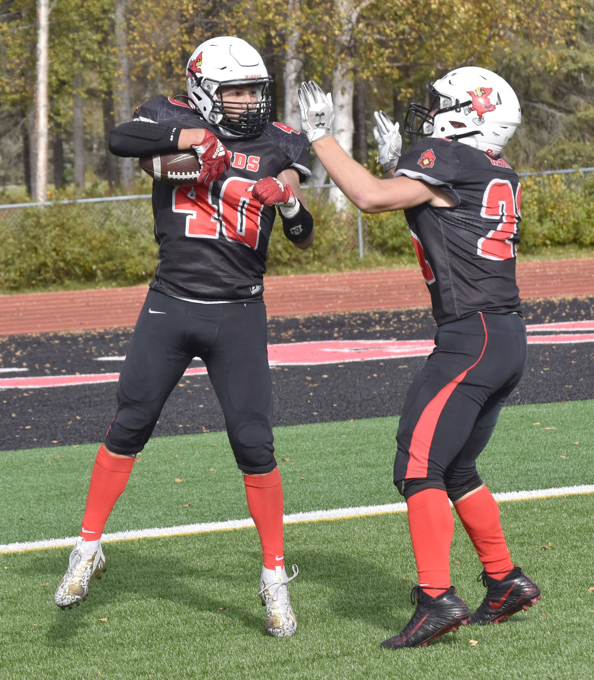 Kenai Central’s Bobby Hayes celebrates his touchdown with William Wilson on Saturday, Sept. 23, 2023, at Ed Hollier Field at Kenai Central High School in Kenai, Alaska. (Photo by Jeff Helminiak/Peninsula Clarion)