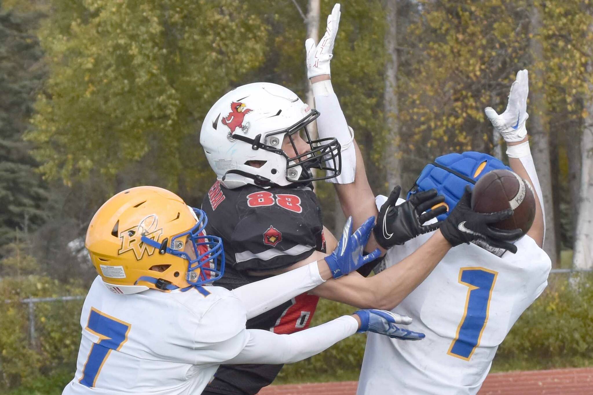 Barrow's Eric Librado and Angelo Reyes break up a pass intended for Kenai Central's Sawyer Vann on Saturday, Sept. 23, 2023, at Ed Hollier Field at Kenai Central High School in Kenai, Alaska. (Photo by Jeff Helminiak/Peninsula Clarion)