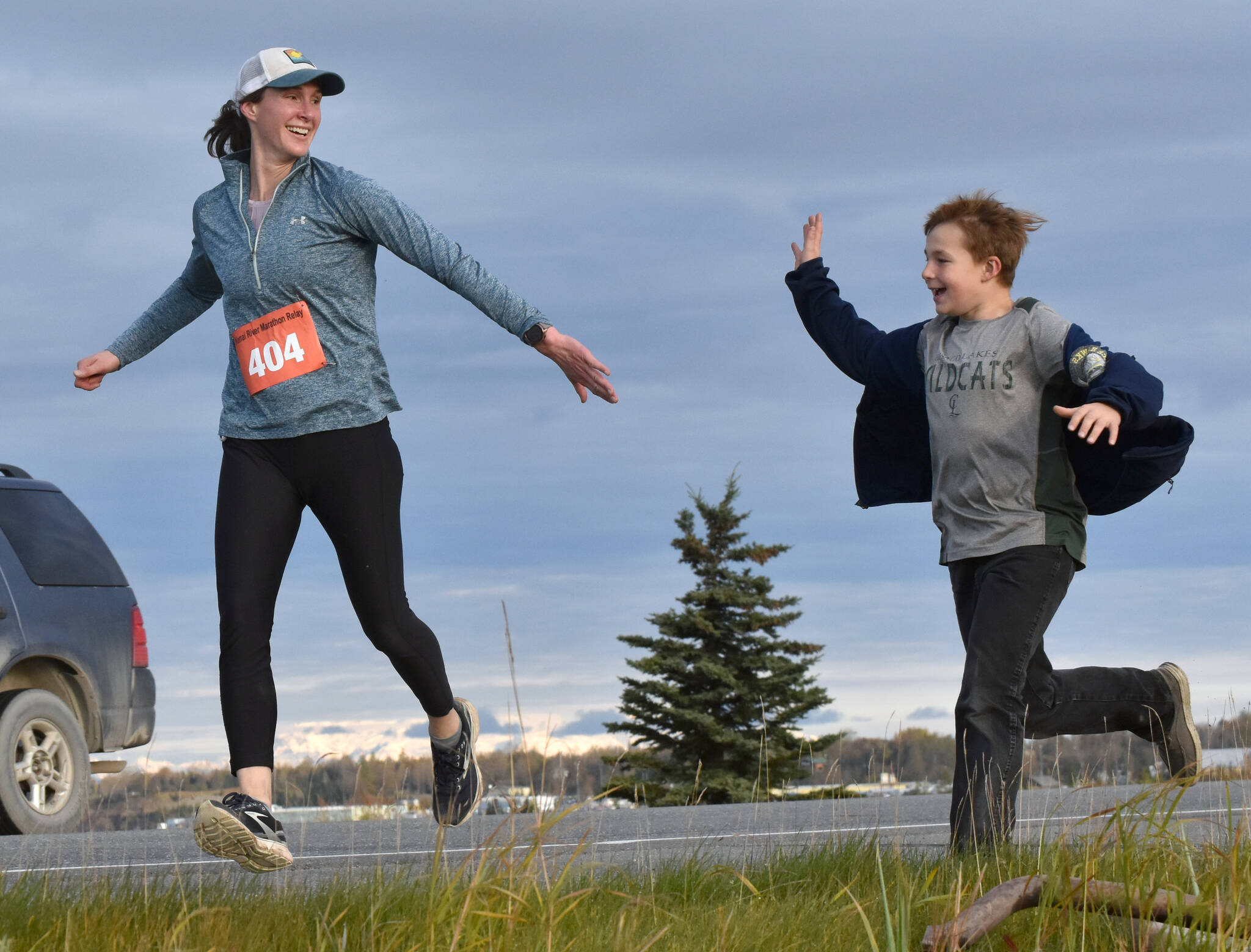 Amy Anderson gets encouragement from her son, Everett, in the marathon relay at the Kenai River Marathon on Sunday, Sept. 24, 2023, in Kenai, Alaska. Anderson teamed with Bethany Nyboer, Katy Coseglia and Chelsea Wingard to finish fourth with Soar B.A.C.K.’s. (Photo by Jeff Helminiak/Peninsula Clarion)