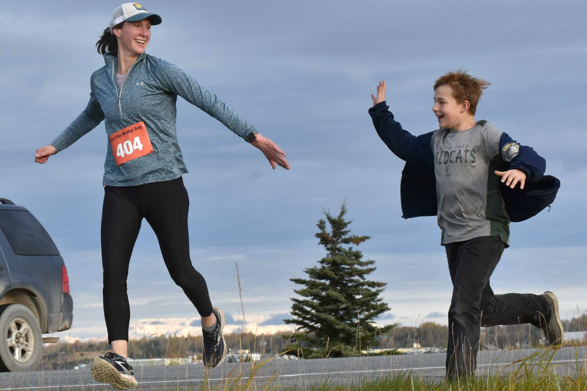 Amy Anderson gets encouragement from her son, Everett, in the marathon relay at the Kenai River Marathon on Sunday, Sept. 24, 2023, in Kenai, Alaska. Anderson teamed with Bethany Nyboer, Katy Coseglia and Chelsea Wingard to finish fourth with Soar B.A.C.K.'s. (Photo by Jeff Helminiak/Peninsula Clarion)