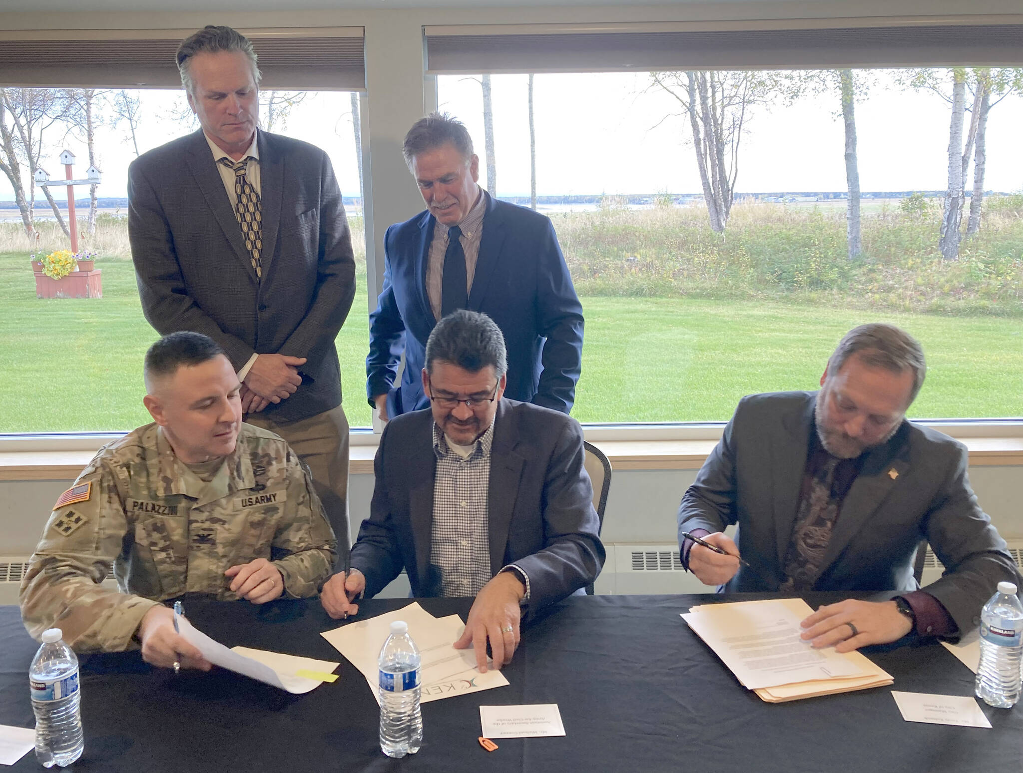 Clockwise from bottom left: U.S. Army Corps of Engineers Alaska Division Commander Col. Jeff Palazzini, Gov. Mike Dunleavy, Kenai Mayor Brian Gabriel, Kenai City Manager Terry Eubank and Assistant Secretary of the Army for Civil Works Michael Connor participate in a signing ceremony for a project partnership agreement for the Kenai Bluff Stabilization Project at the Kenai Senior Center on Monday, Sept. 25, 2023, in Kenai, Alaska. (Jeff Helminiak/Peninsula Clarion)