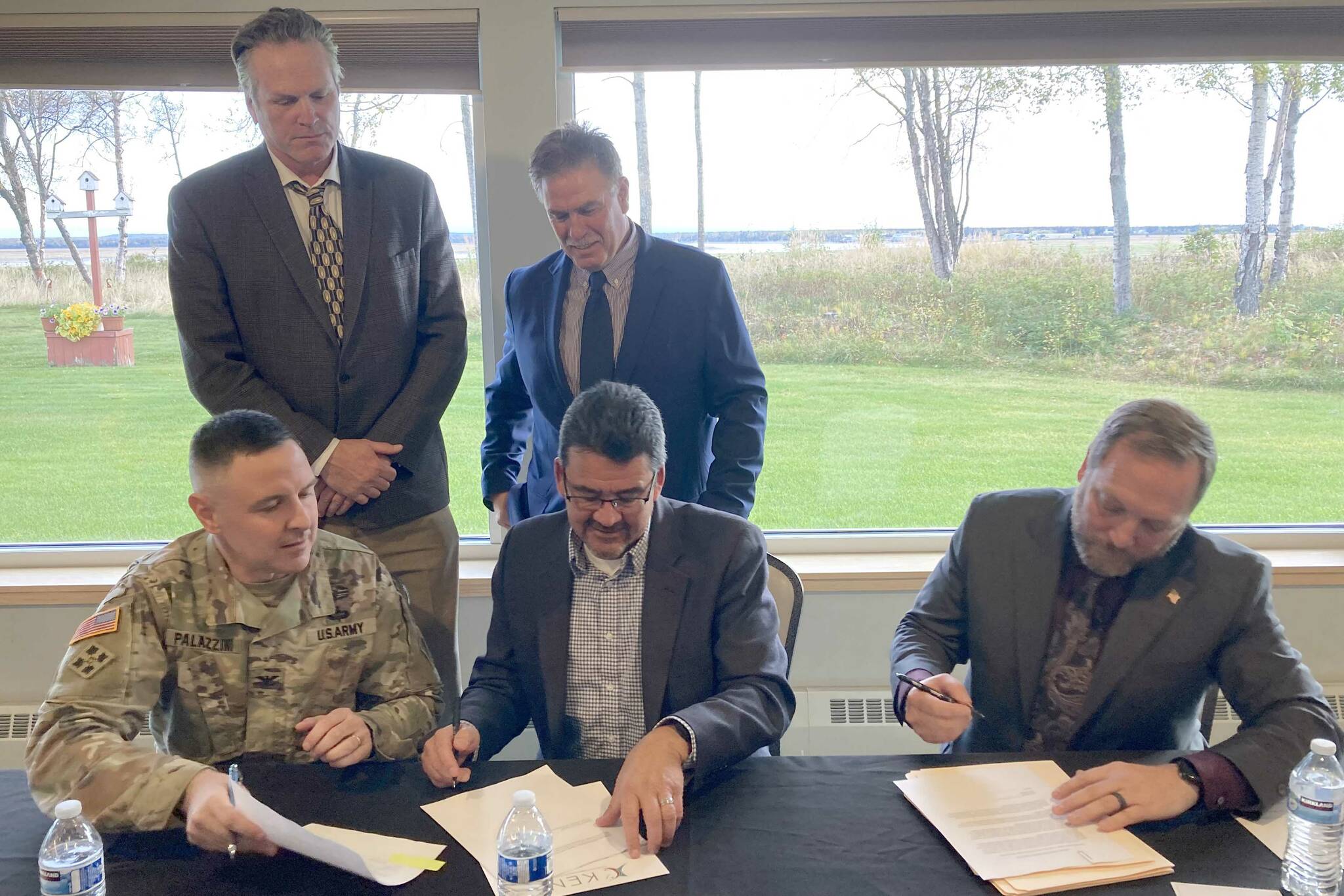 Clockwise from bottom left: U.S. Army Corps of Engineers Alaska Division Commander Col. Jeff Palazzini, Gov. Mike Dunleavy, Kenai Mayor Brian Gabriel, Kenai City Manager Terry Eubank and Assistant Secretary of the Army for Civil Works Michael Connor participate in a signing ceremony for a project partnership agreement for the Kenai Bluff Stabilization Project at the Kenai Senior Center on Monday, Sept. 25, 2023, in Kenai, Alaska. (Jeff Helminiak/Peninsula Clarion)