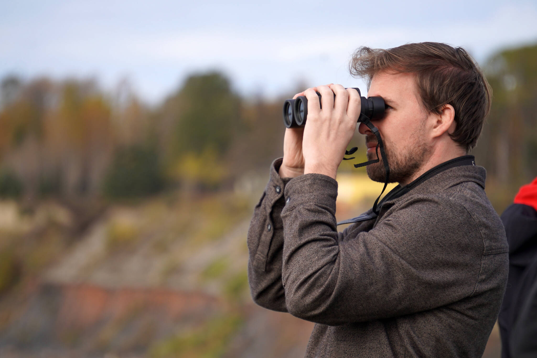 Jimmy Peniston searches the waters of the Kenai River for sightings of Cook Inlet belugas during Belugas Count! at the Kenai Bluff Overlook in Kenai, Alaska on Saturday, Sept. 23, 2023. (Jake Dye/Peninsula Clarion)