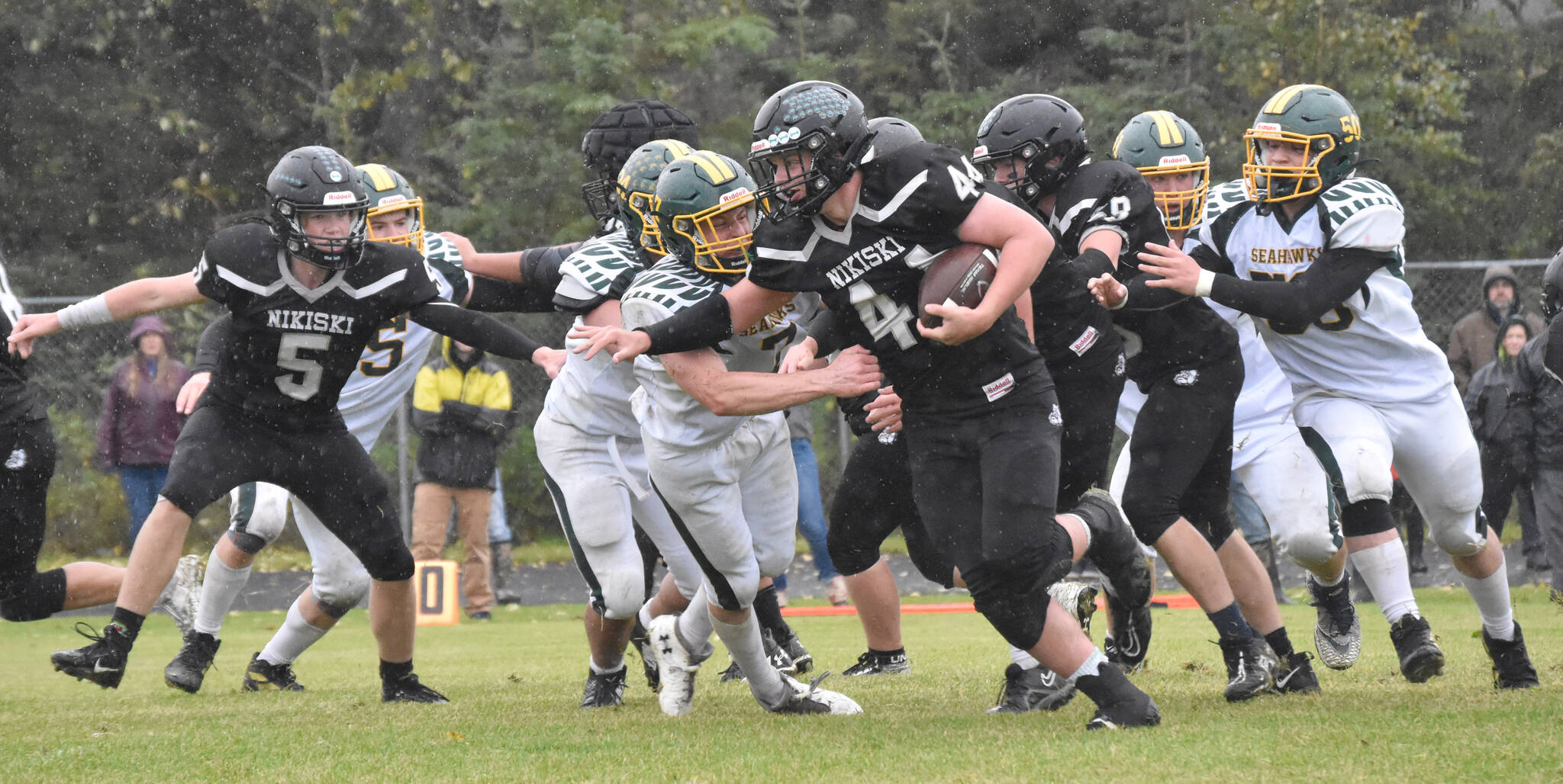 Nikiski’s Truit McCaughey tries to break the tackle of Seward’s Judah Brueckner on Saturday, Sept. 16, 2023, at Nikiski Middle-High School in Nikiski, Alaska. (Photo by Jeff Helminiak/Peninsula Clarion)